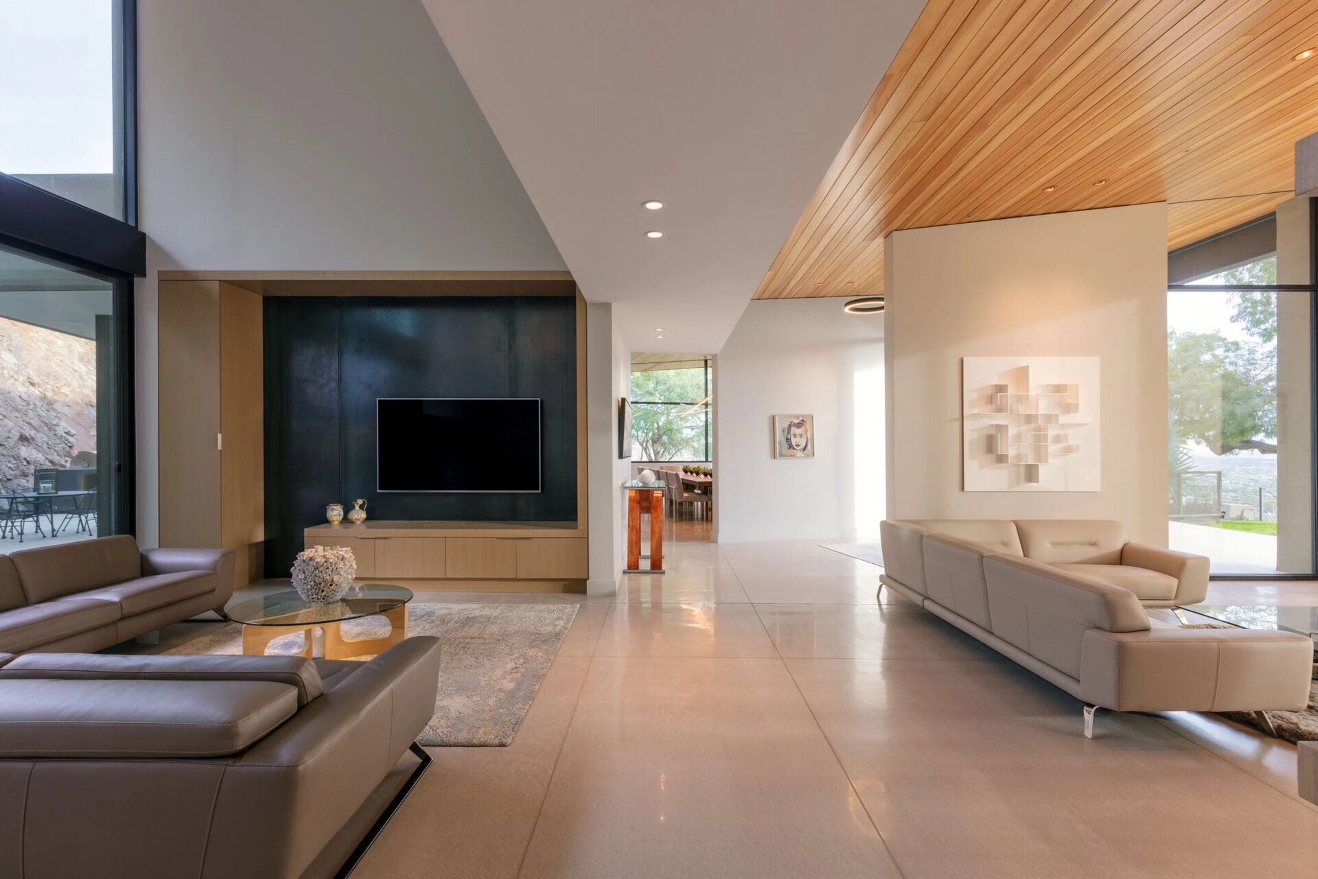 High ceilings, terrazzo concrete floors, and easy access to outdoor patios give these living spaces an airy feel.