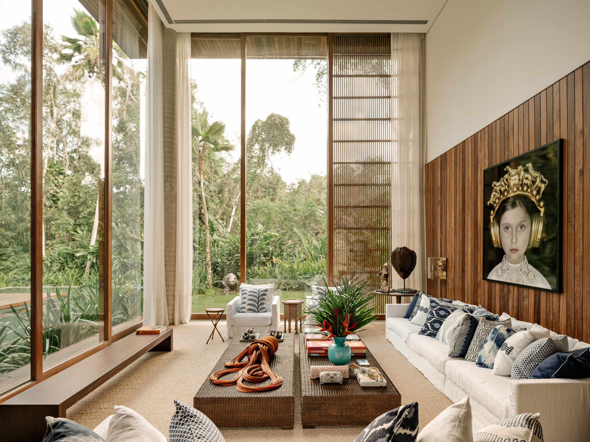 Step inside a coastal-inspired living room featuring natural textures, custom furnishings, artwork, and a timeless blue-and-white palette.