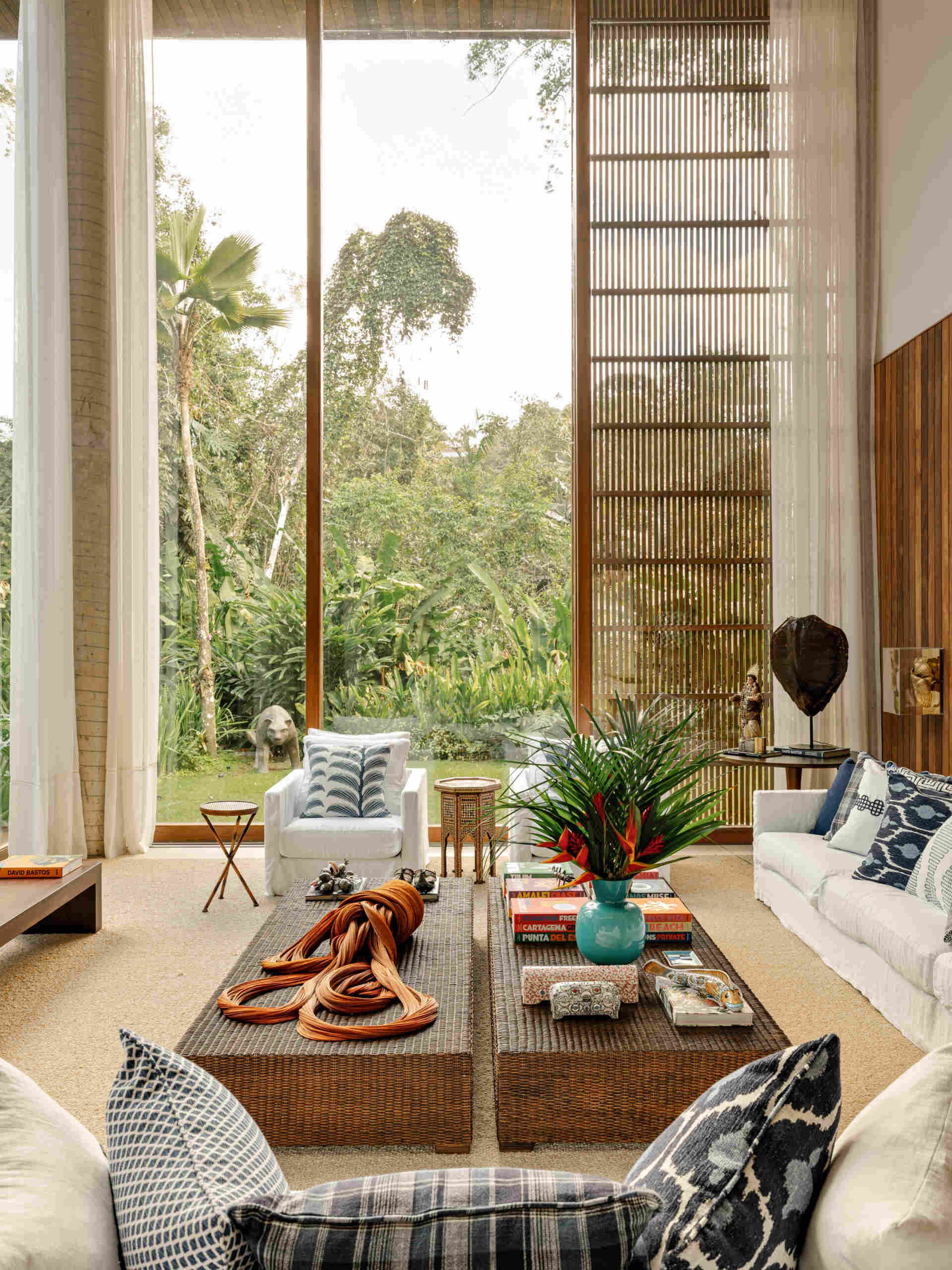 Step inside a coastal-inspired living room featuring natural textures, custom furnishings, artwork, and a timeless blue-and-white palette.