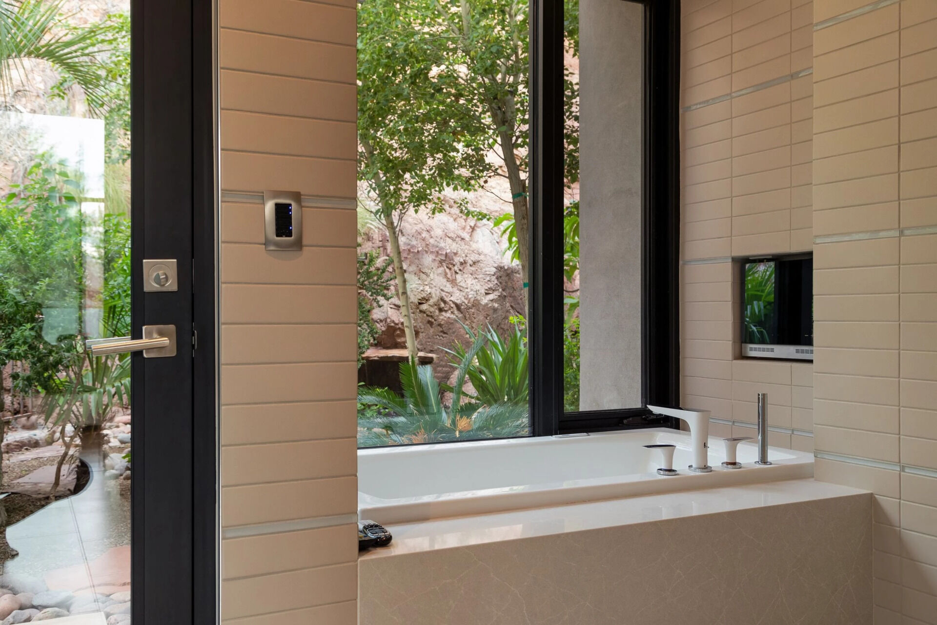 loor-to-ceiling tiles, dual vanities, and a private garden patio make this bathroom stand out.