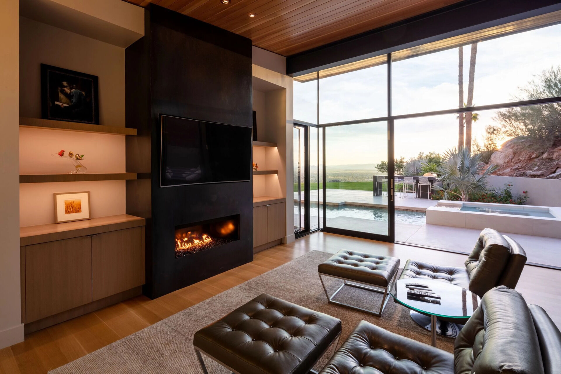 A warm timber bedroom, fireplace lounge, and peaceful home office showcase the quieter side of this Arizona home.