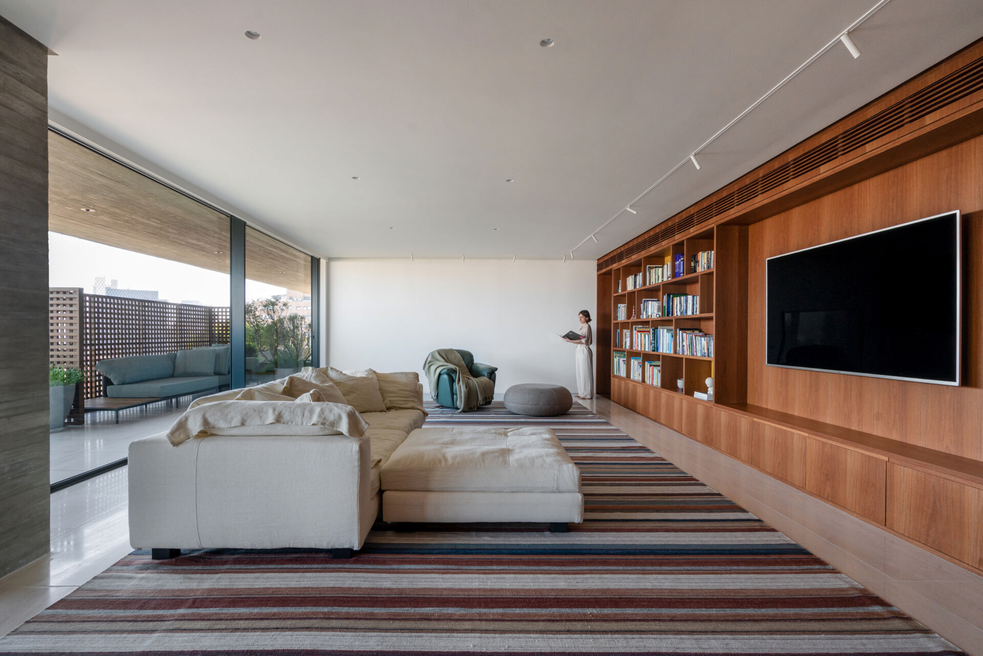 This media room combines a library, TV lounge and children's play area with beautifully integrated custom shelving.