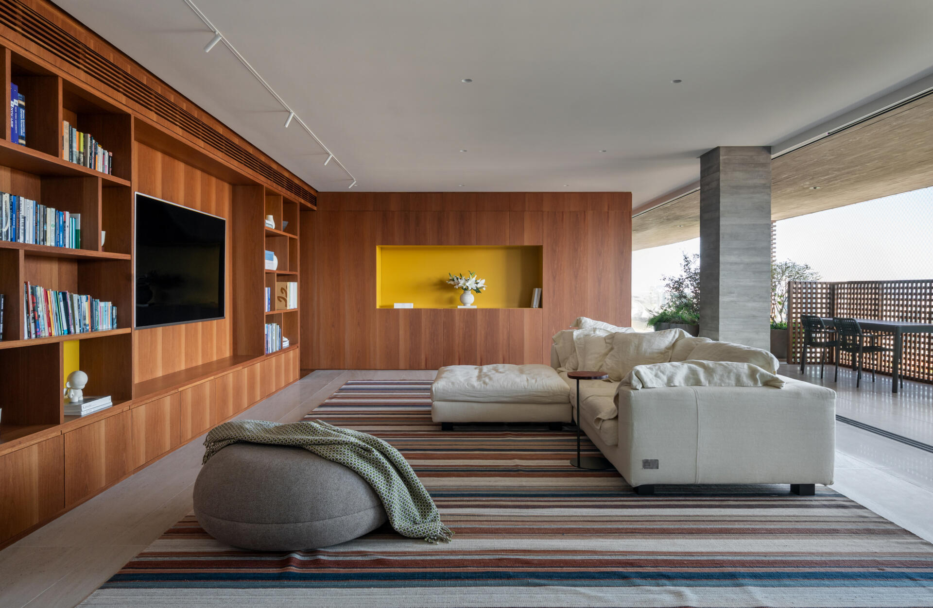 This media room combines a library, TV lounge and children's play area with beautifully integrated custom shelving.