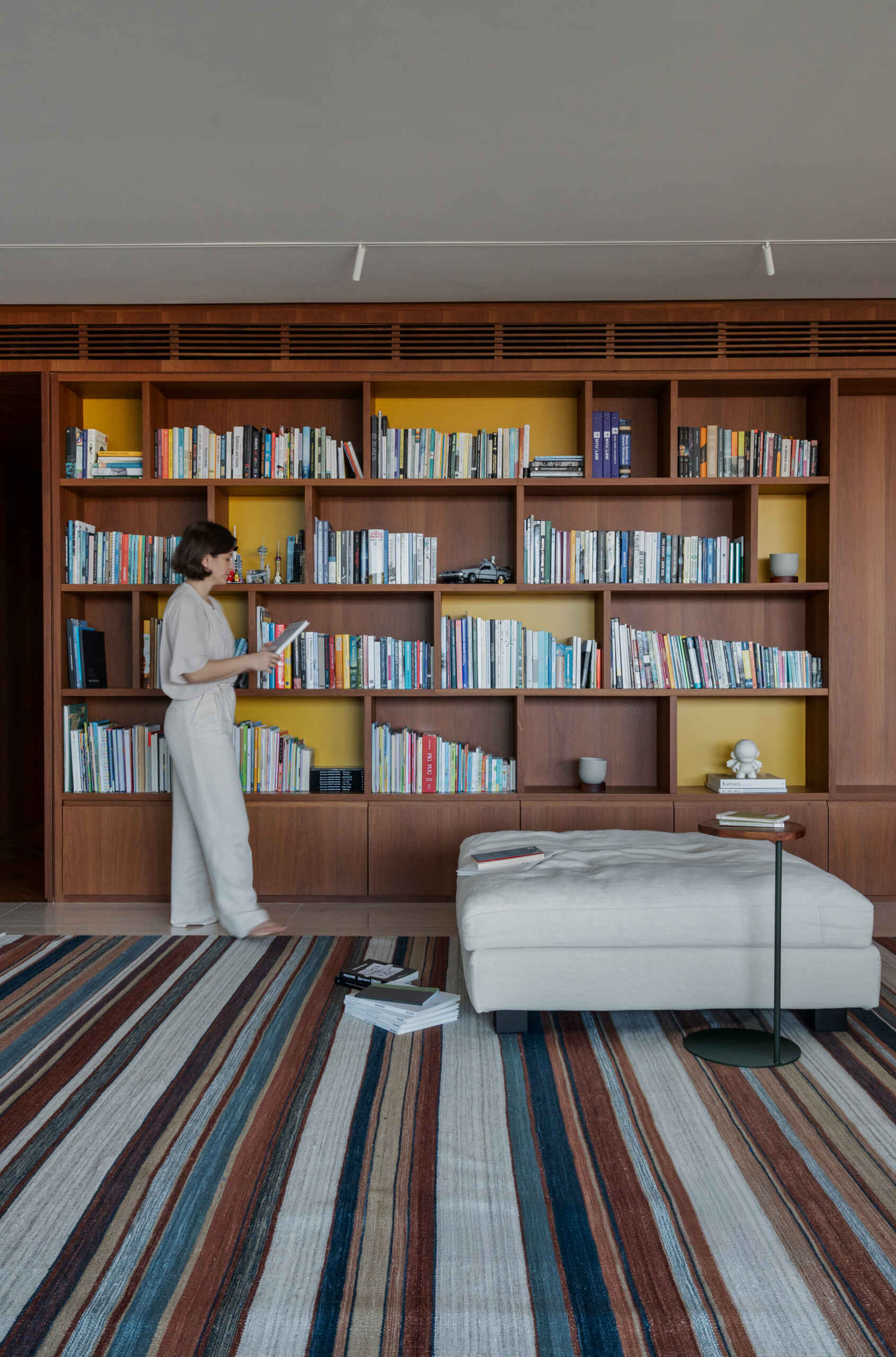 This media room combines a library, TV lounge and children's play area with beautifully integrated custom shelving.