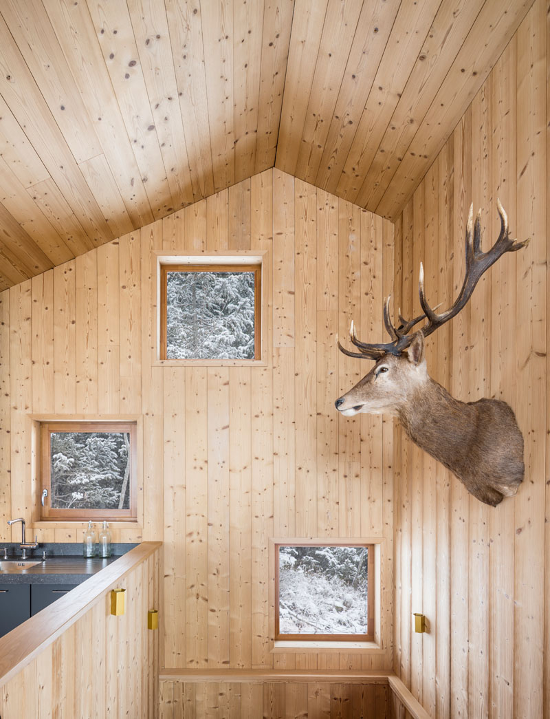 Vaulted ceilings, matte black kitchen cabinets, panoramic mountain views and a dramatic fireplace make this top-floor living space unforgettable.