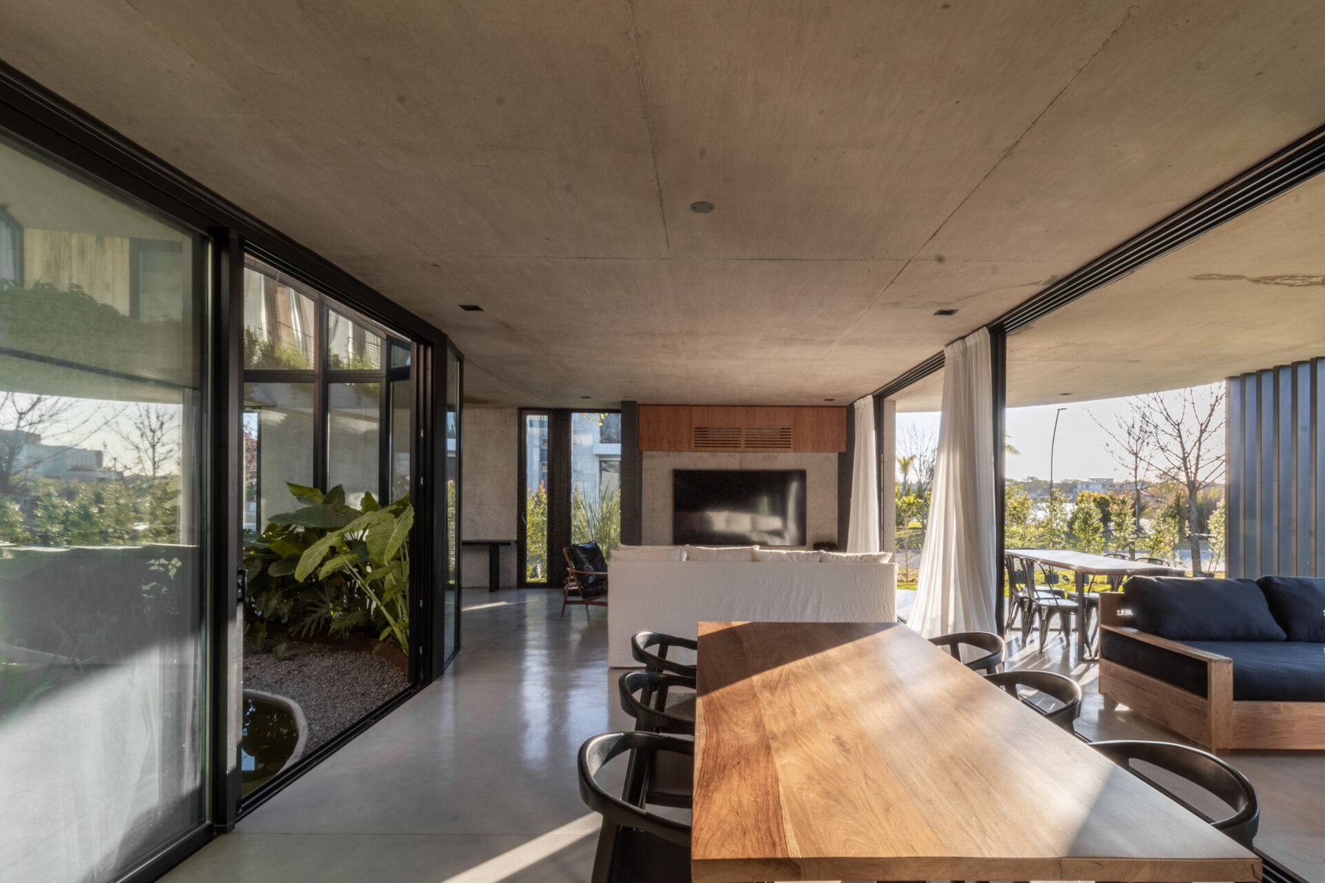 Take a closer look at the bright dining room and modern kitchen where open views and flowing architecture create welcoming gathering spaces.