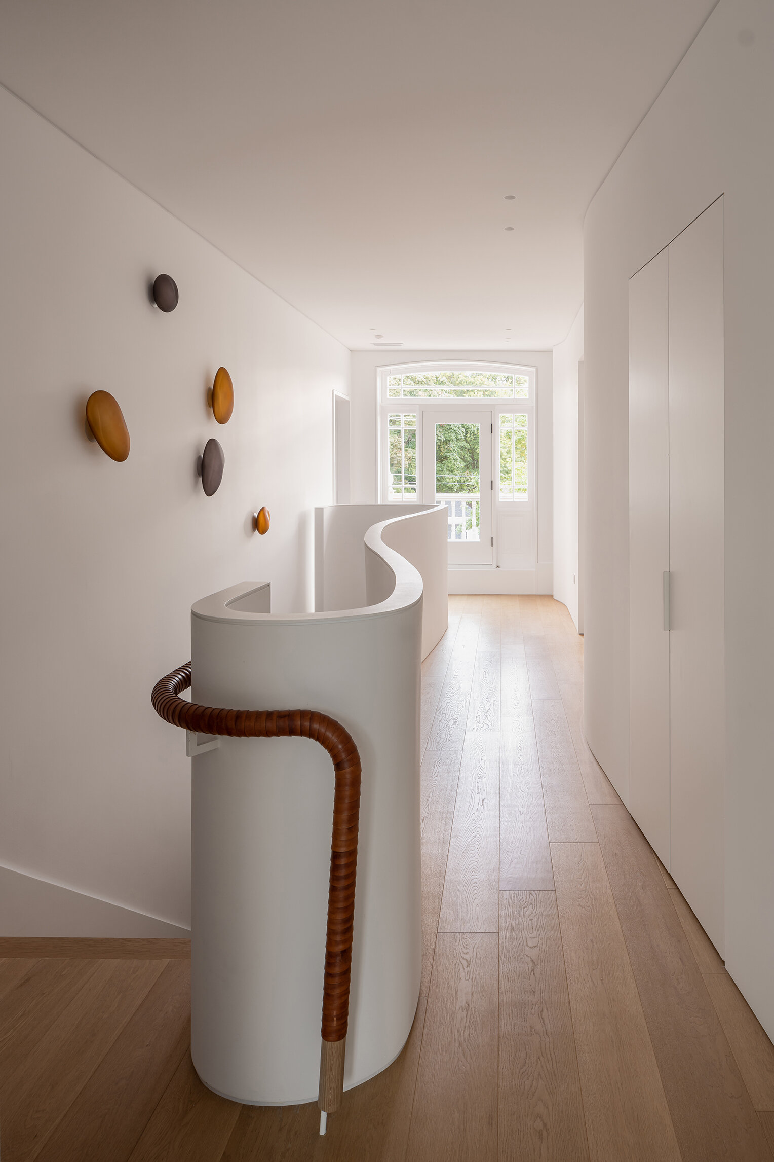 Sculptural stairs and a flowing second-floor hallway create one of the most memorable architectural moments in Snider House.