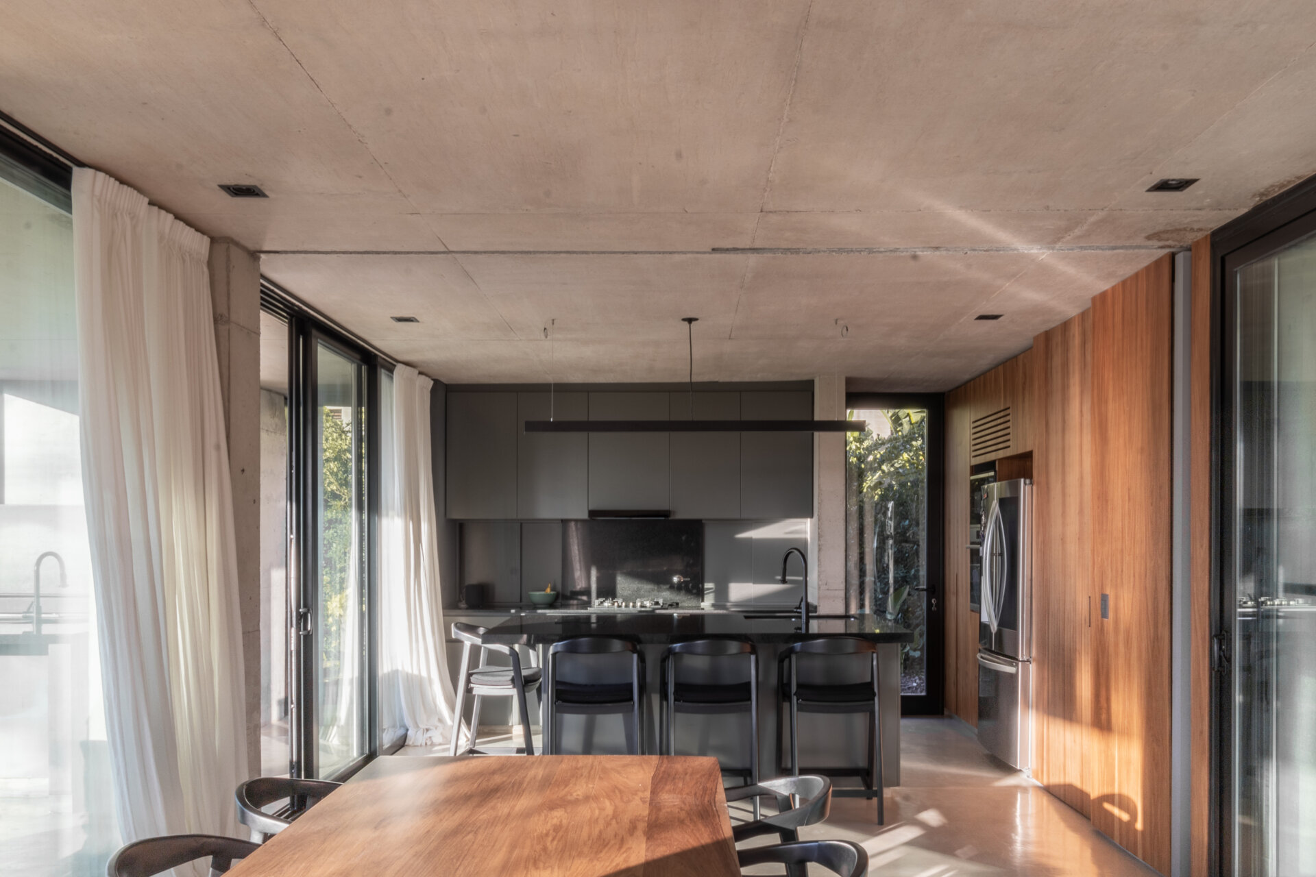 Take a closer look at the bright dining room and modern kitchen where open views and flowing architecture create welcoming gathering spaces.