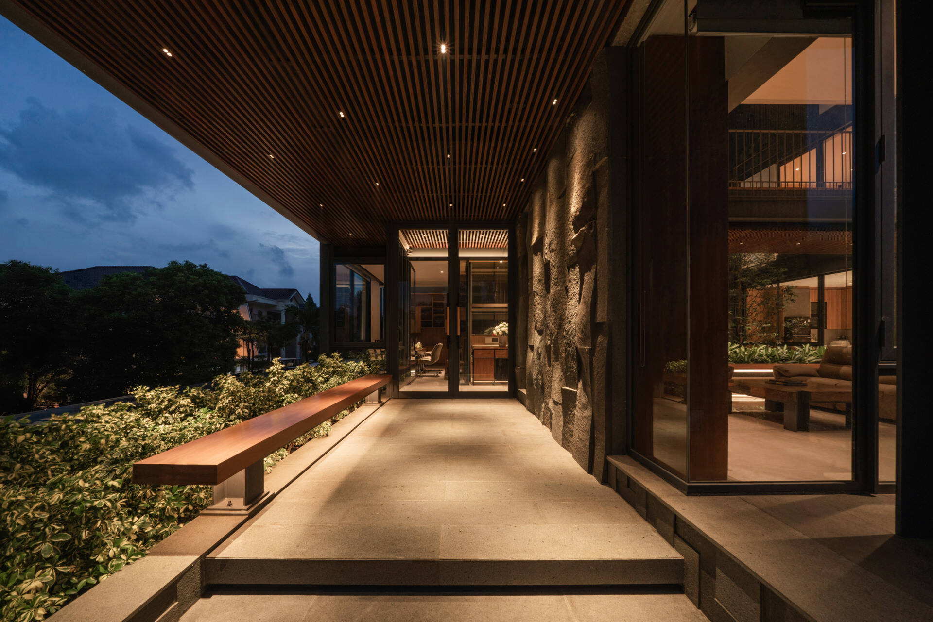 A covered outdoor living area and front swimming pool blur the line between indoor comfort and tropical outdoor living.