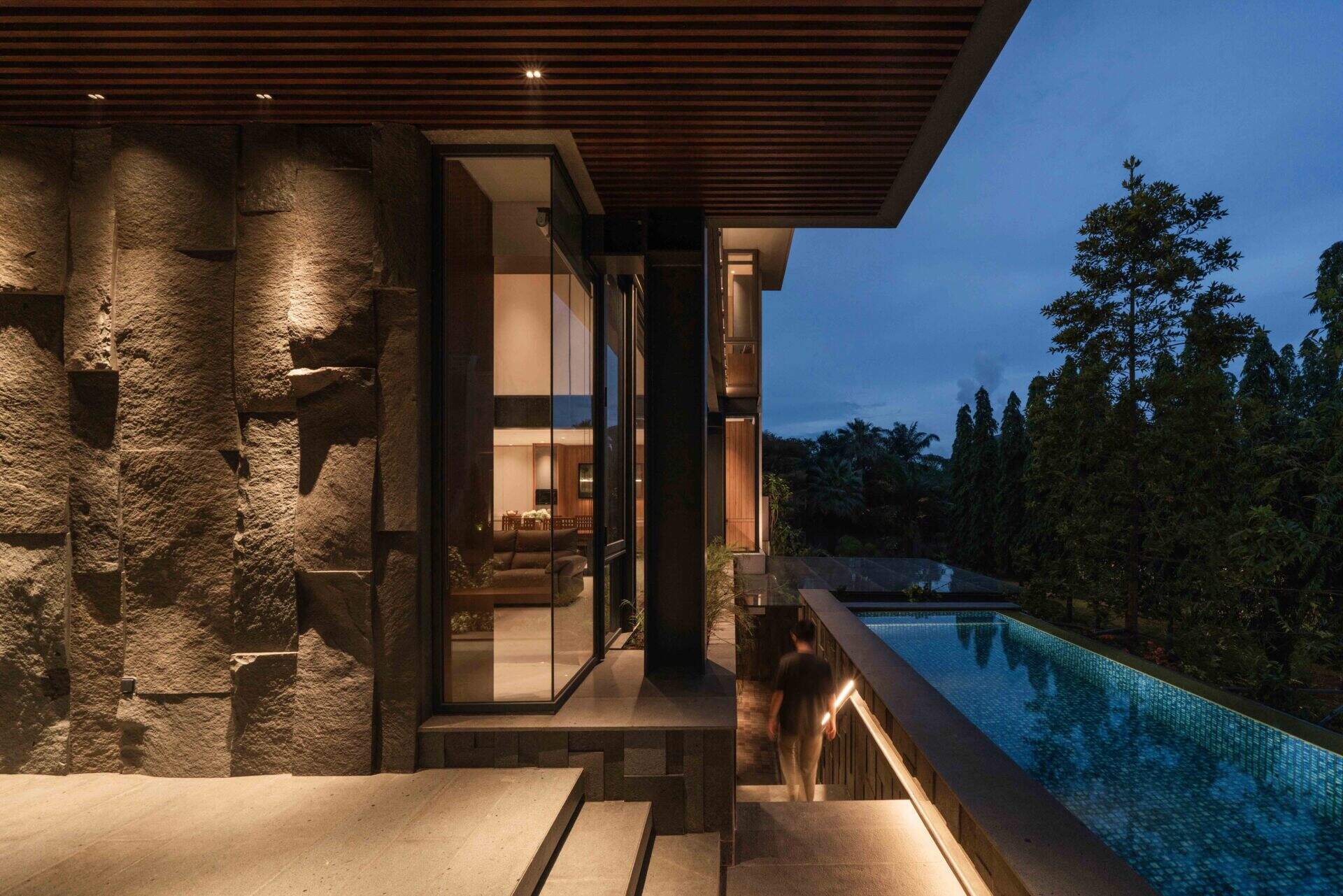 Exterior stairs connect the garage with the home's landscaped outdoor spaces while continuing the modern architectural design.
