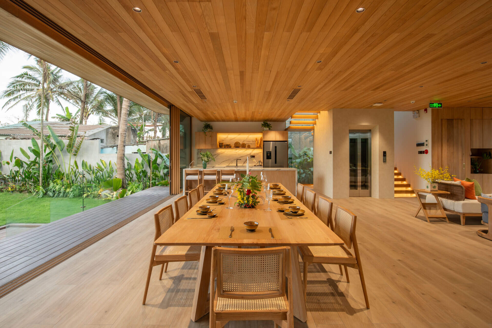 A light-filled dining area sits within the villa's open-plan layout, creating an inviting place for family meals and entertaining.