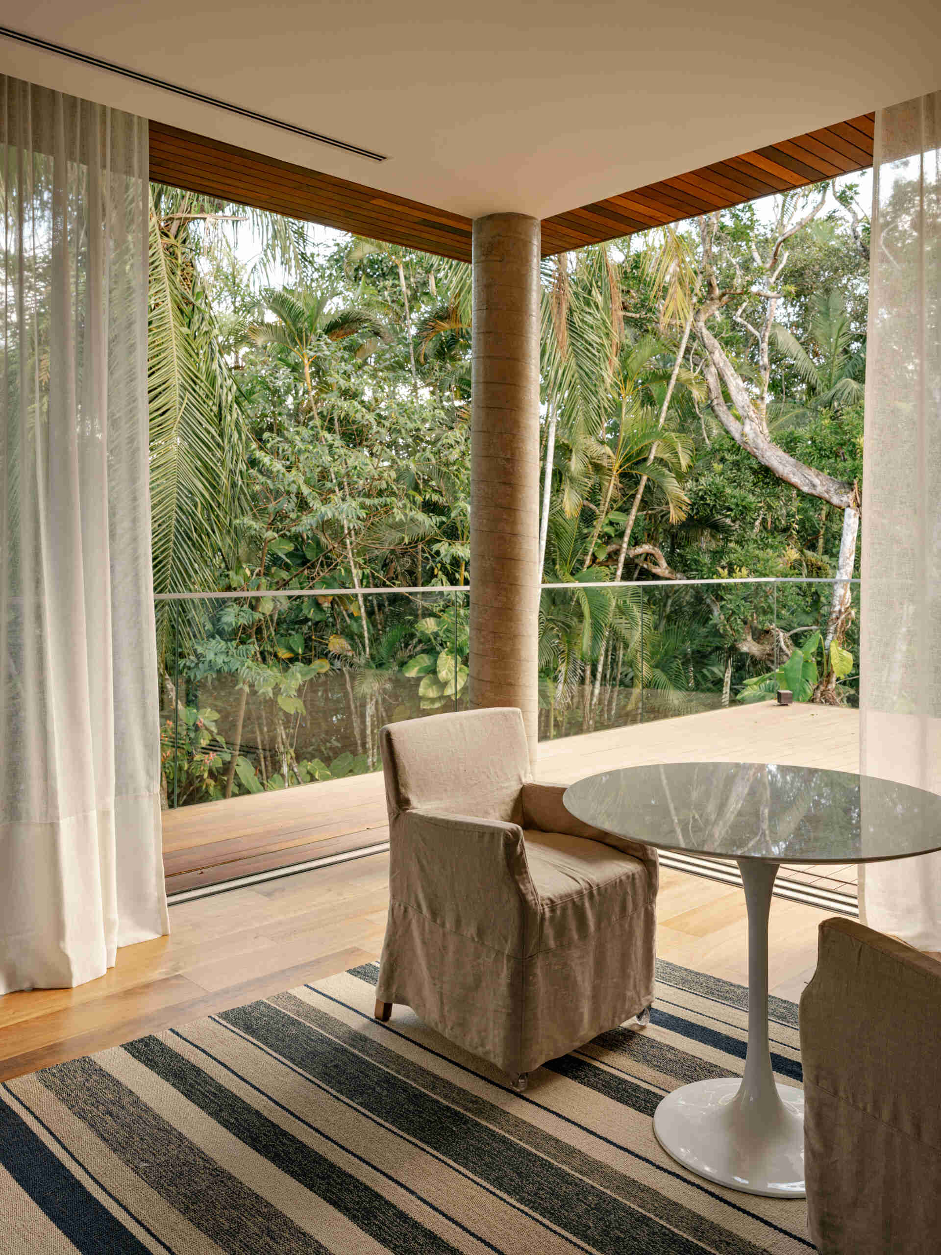 Tour a serene primary suite featuring full-opening windows, natural textures, and peaceful balcony views.
