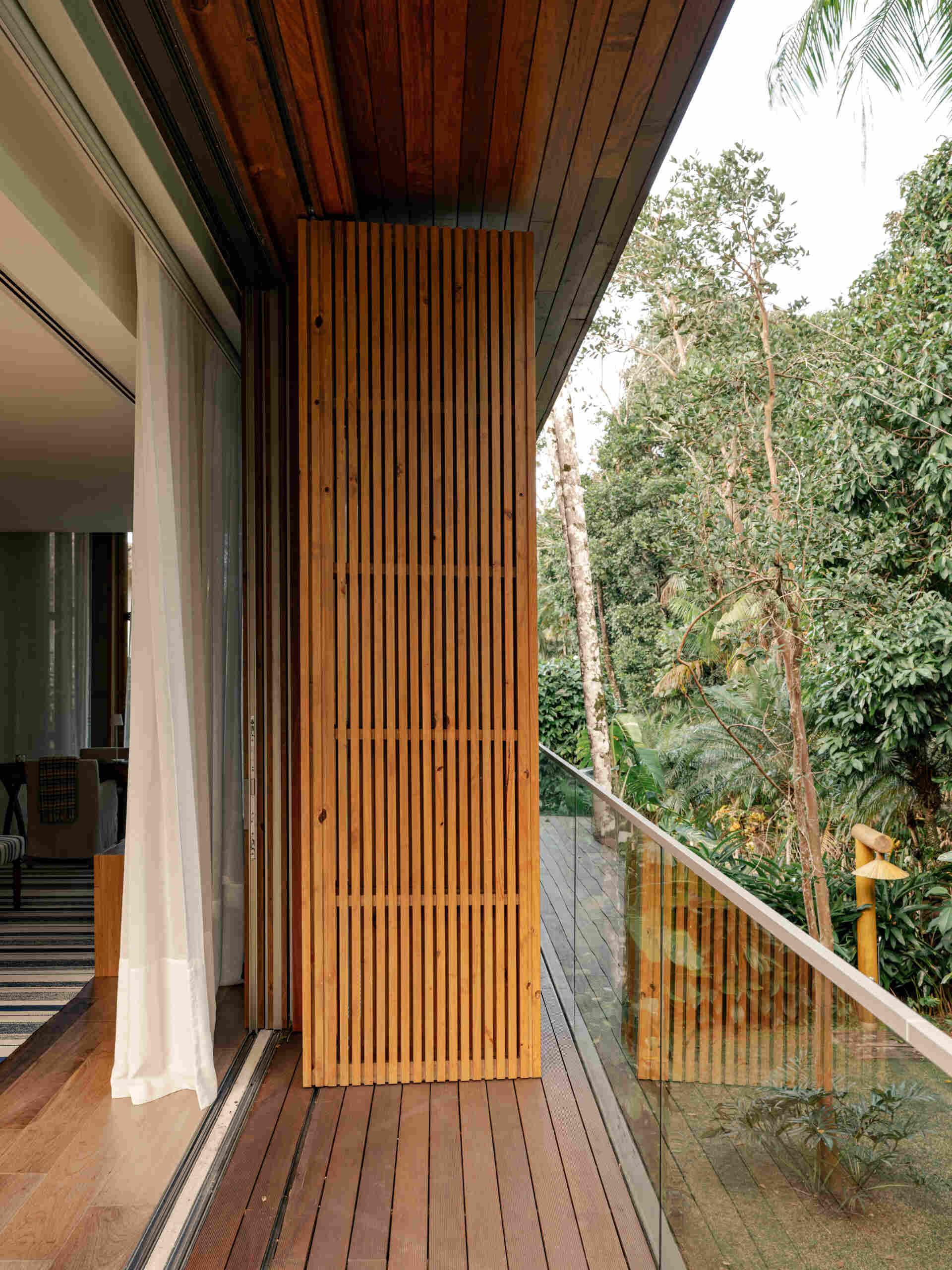 Tour a serene primary suite featuring full-opening windows, natural textures, and peaceful balcony views.