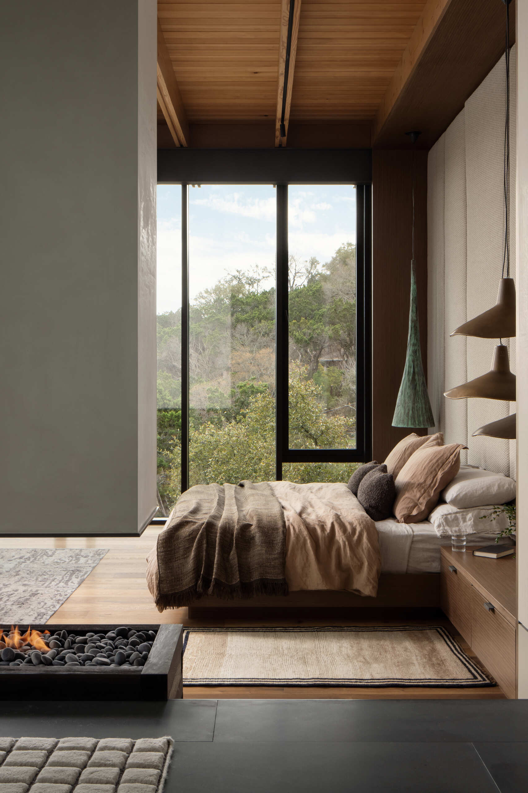 Wake up to panoramic Texas Hill Country views from this beautifully detailed primary bedroom.