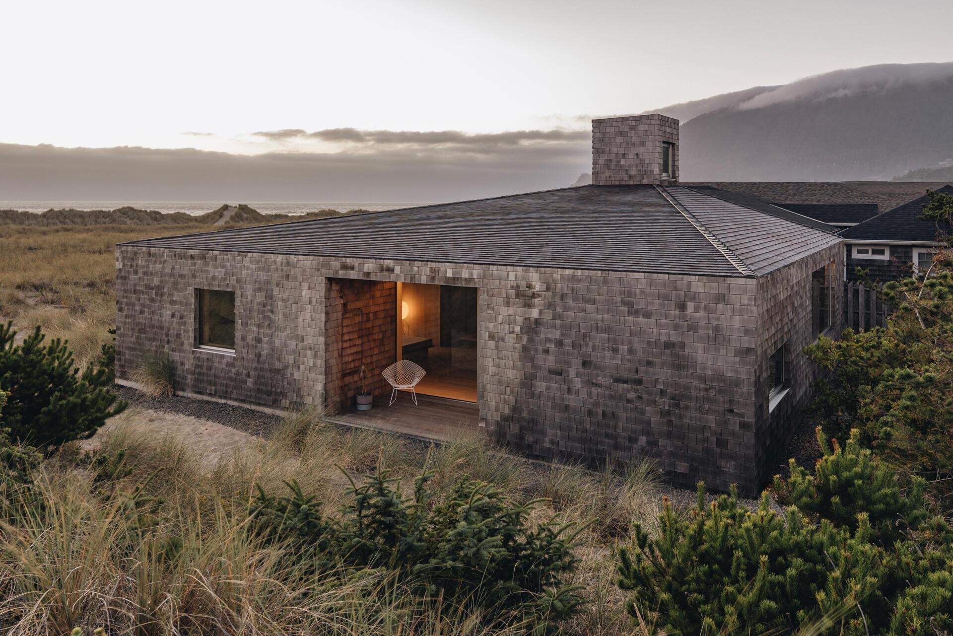 Dune House by Waechter Architecture pairs weathered cedar with warm oak interiors on the North Oregon Coast. See how simple materials, panoramic windows, and minimalist design create a timeless beach home.