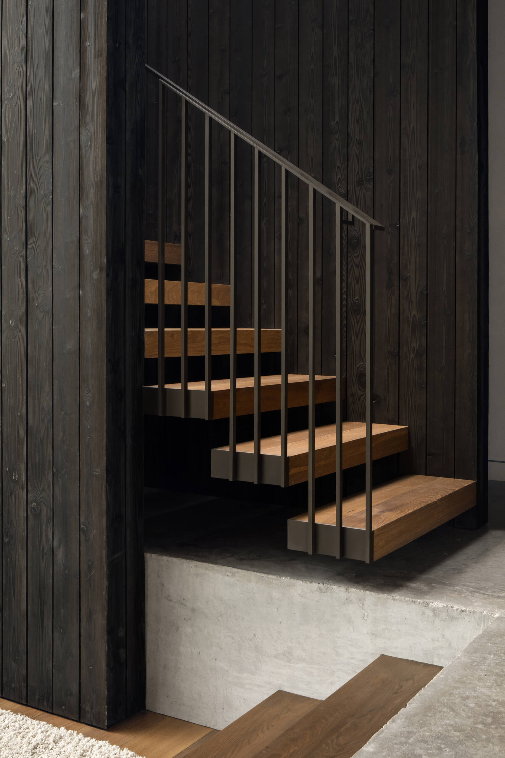 These stairs reveal the transition between the home's solid stone base and floating upper pavilion.