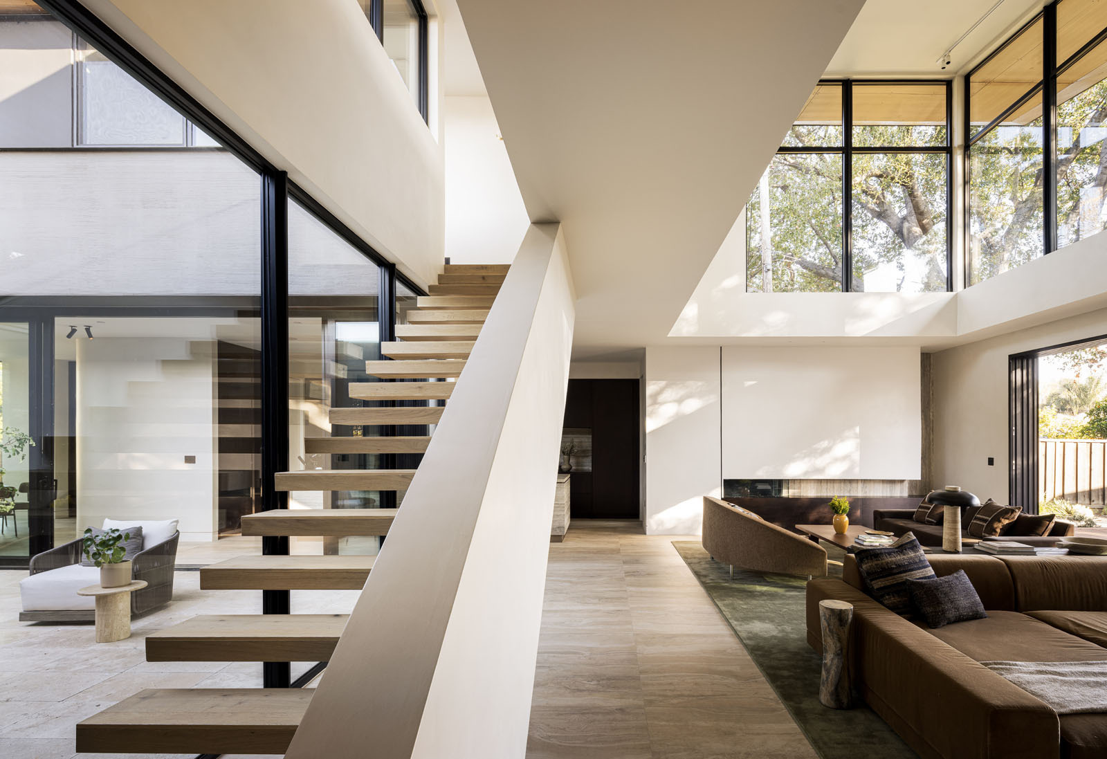 Explore the breezeway and upper-level bridge that connect family spaces while overlooking the bright living room below.