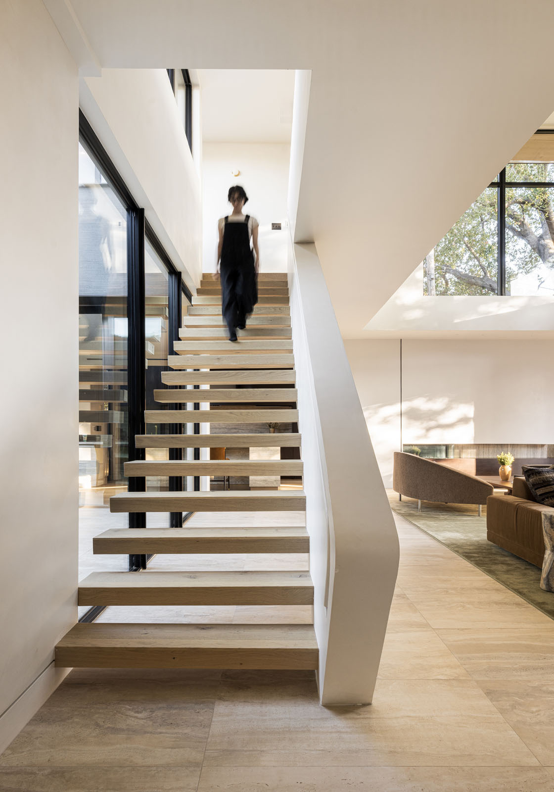 Explore the breezeway and upper-level bridge that connect family spaces while overlooking the bright living room below.