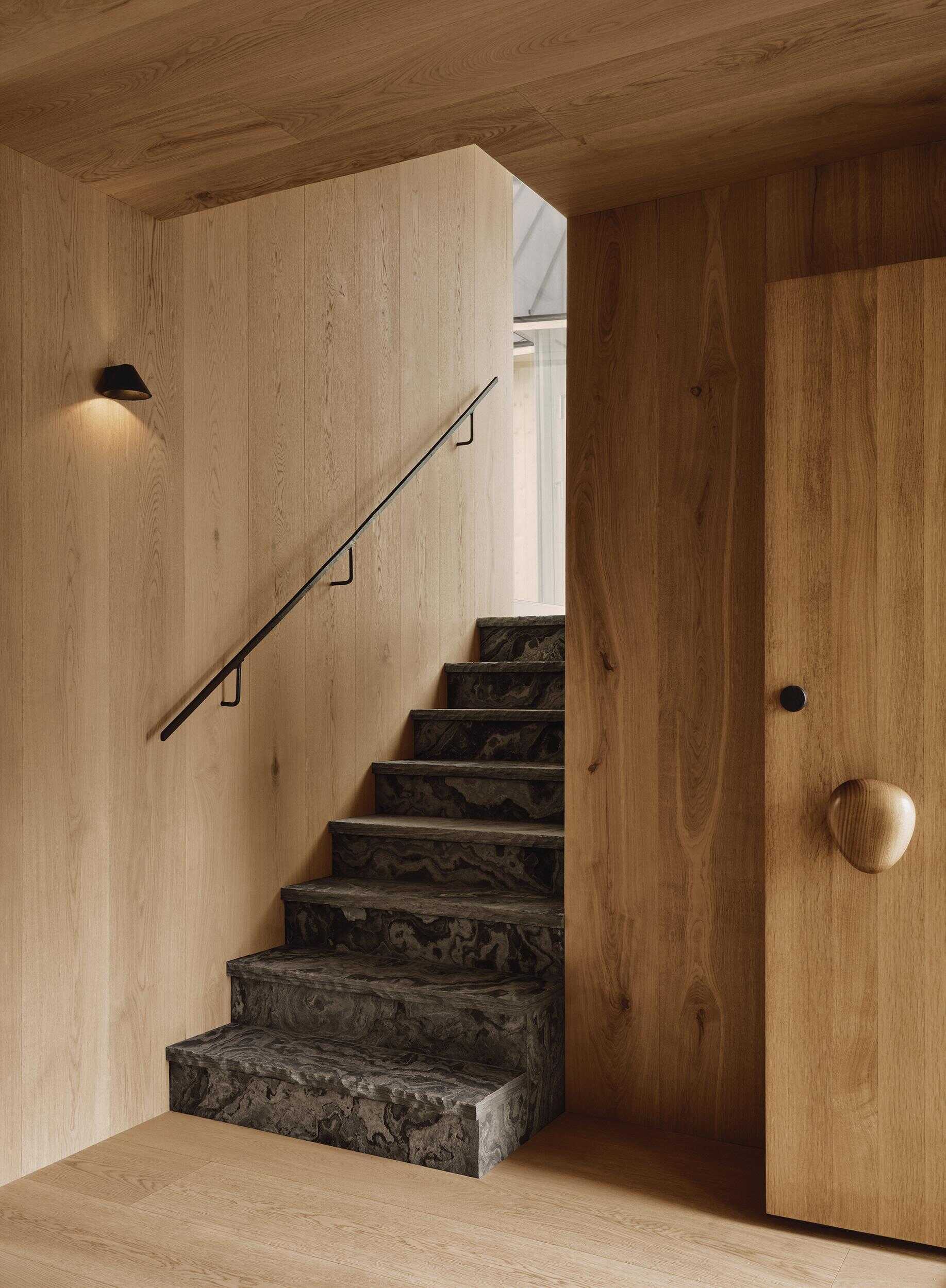See how stairs and changing materials guide you through every level of Pine Island Cottage.