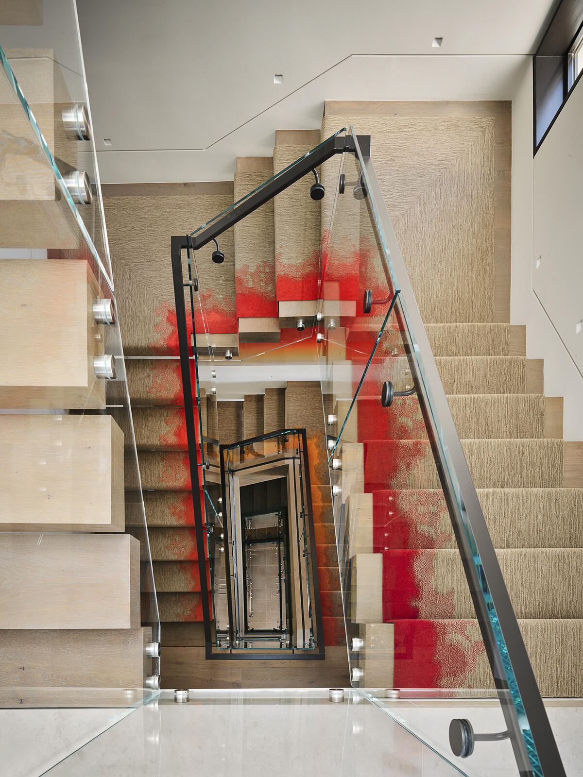 A vibrant stair runner transforms this staircase into the defining feature of the home, weaving a spectrum of color through every level. Paired with contemporary artwork, it creates a bold visual thread that connects the entire interior while turning a functional space into a striking design statement.