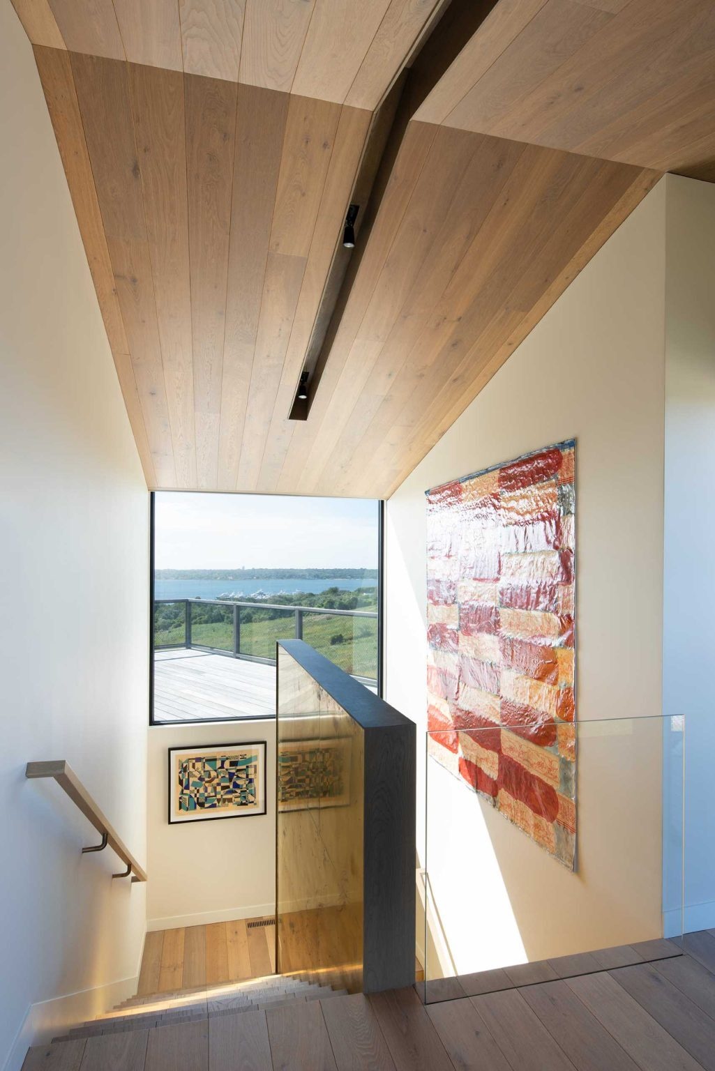 Two shingled cottage-inspired volumes sit above a hidden stone base, giving this Montauk home its distinctive appearance and maximizing every bedroom view.