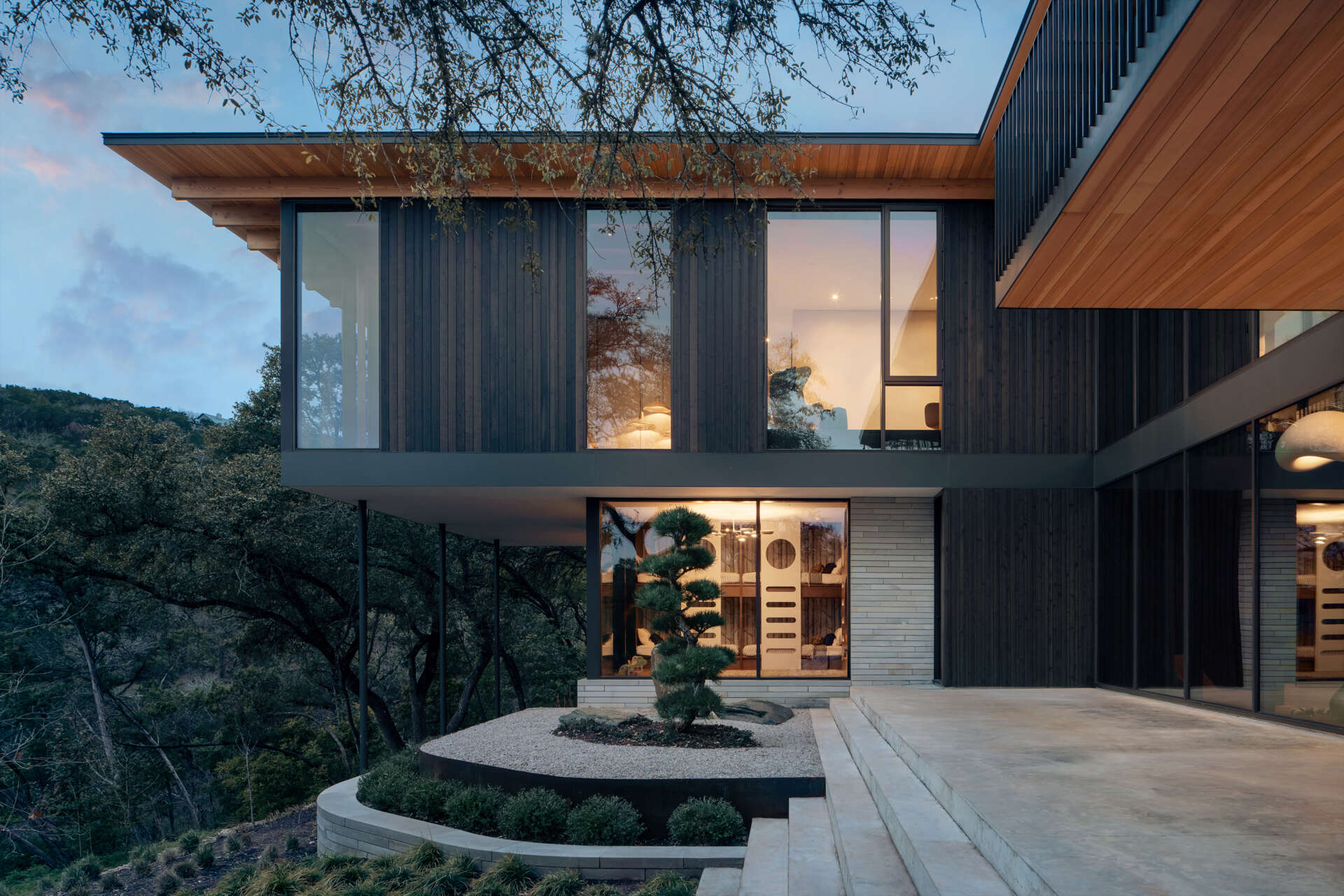 Native gardens and expansive terraces create beautiful outdoor spaces overlooking the Texas Hill Country.