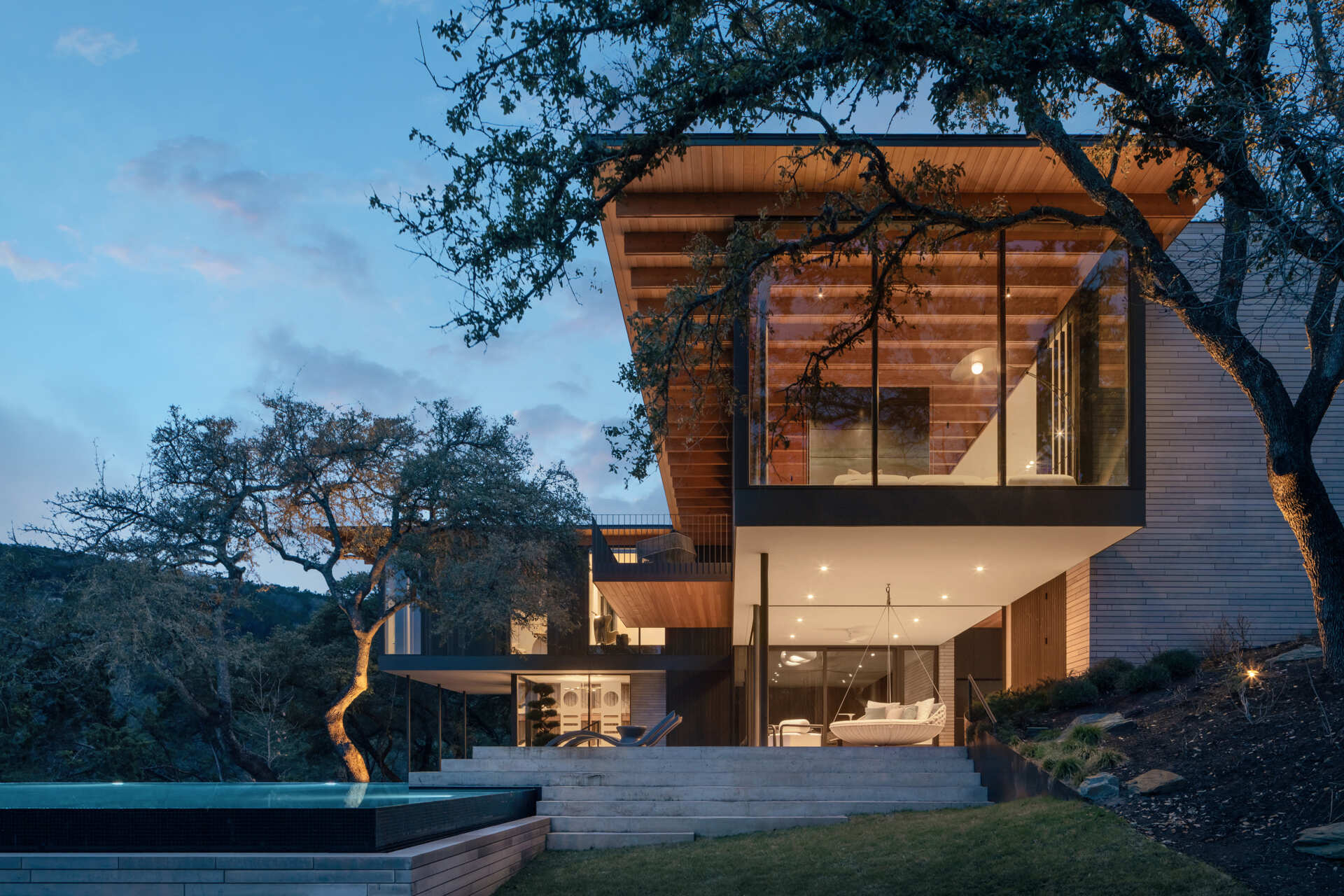 Native gardens and expansive terraces create beautiful outdoor spaces overlooking the Texas Hill Country.
