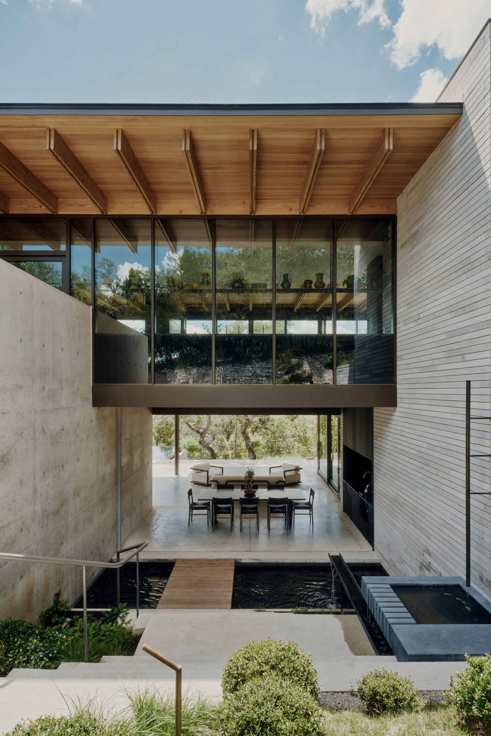 Water features, stone stairs and layered landscaping create an outdoor experience full of variety.