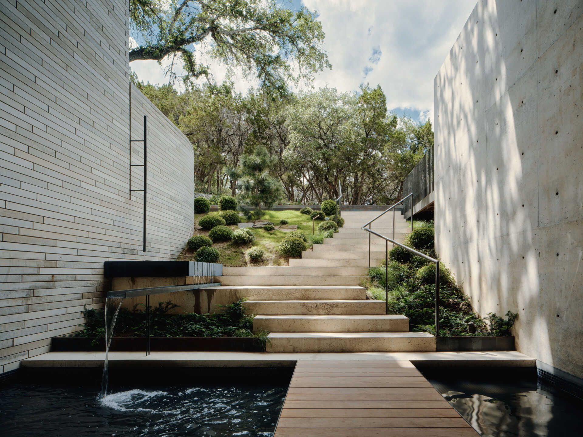 Water features, stone stairs and layered landscaping create an outdoor experience full of variety.