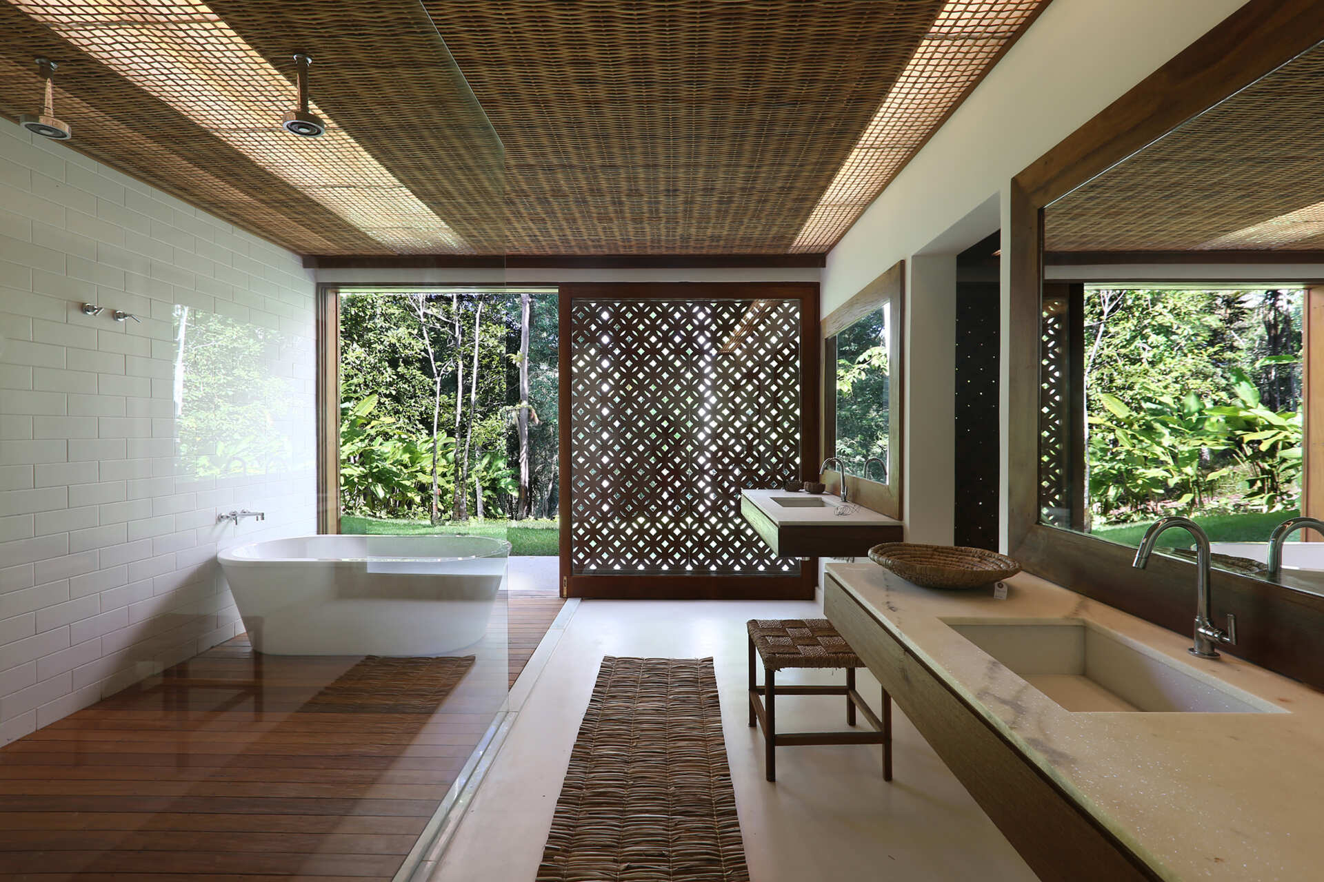 Timber decks, woven palm ceilings and stone vanities create bathrooms that celebrate natural materials and artisan craftsmanship.