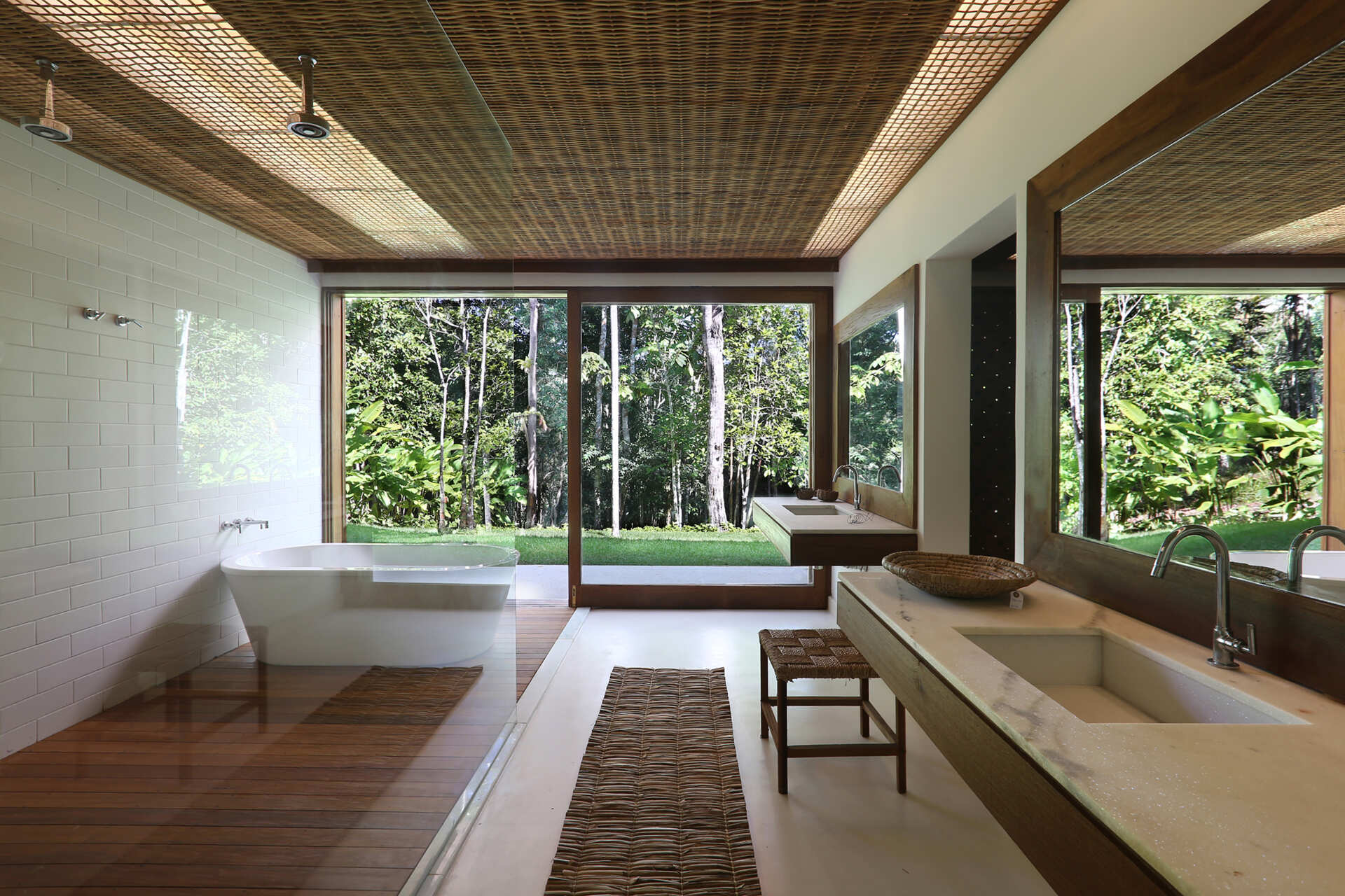 Timber decks, woven palm ceilings and stone vanities create bathrooms that celebrate natural materials and artisan craftsmanship.