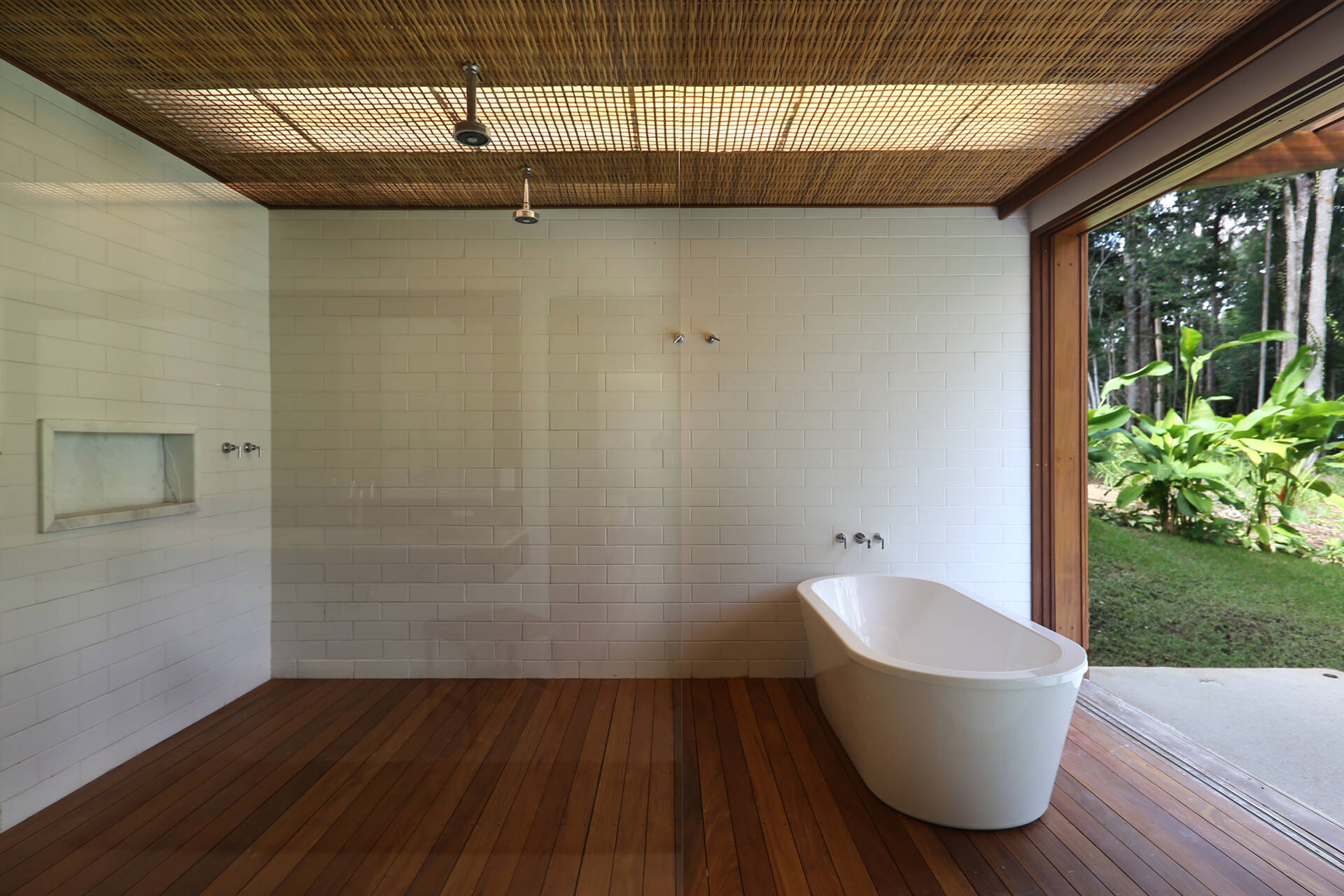 Timber decks, woven palm ceilings and stone vanities create bathrooms that celebrate natural materials and artisan craftsmanship.