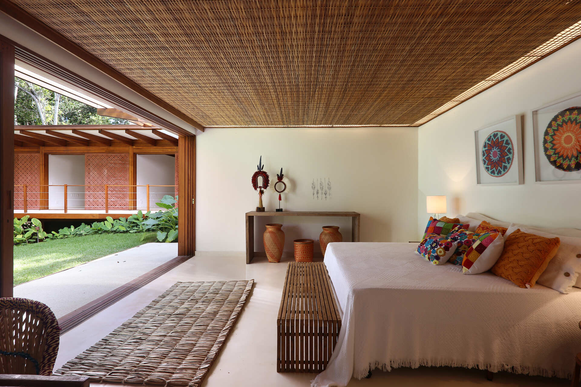 Forest-facing bedrooms feature warm timber details, custom joinery and large openings that maximise natural light and greenery.