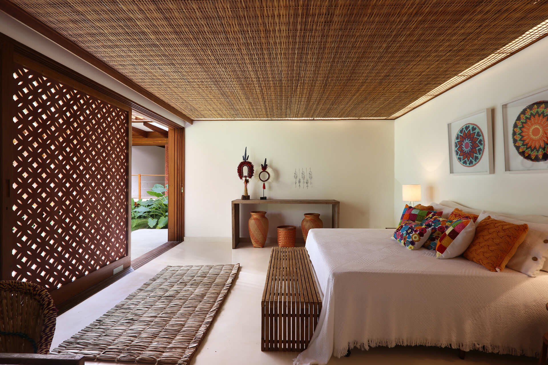 Forest-facing bedrooms feature warm timber details, custom joinery and large openings that maximise natural light and greenery.