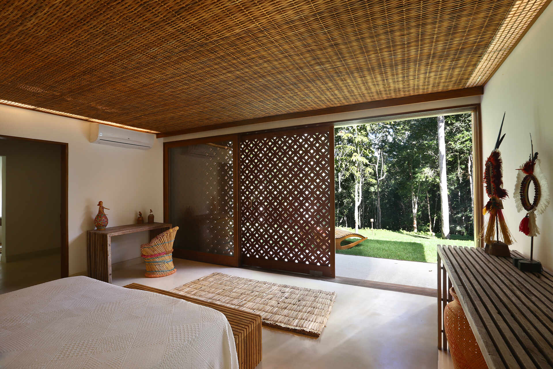 Forest-facing bedrooms feature warm timber details, custom joinery and large openings that maximise natural light and greenery.