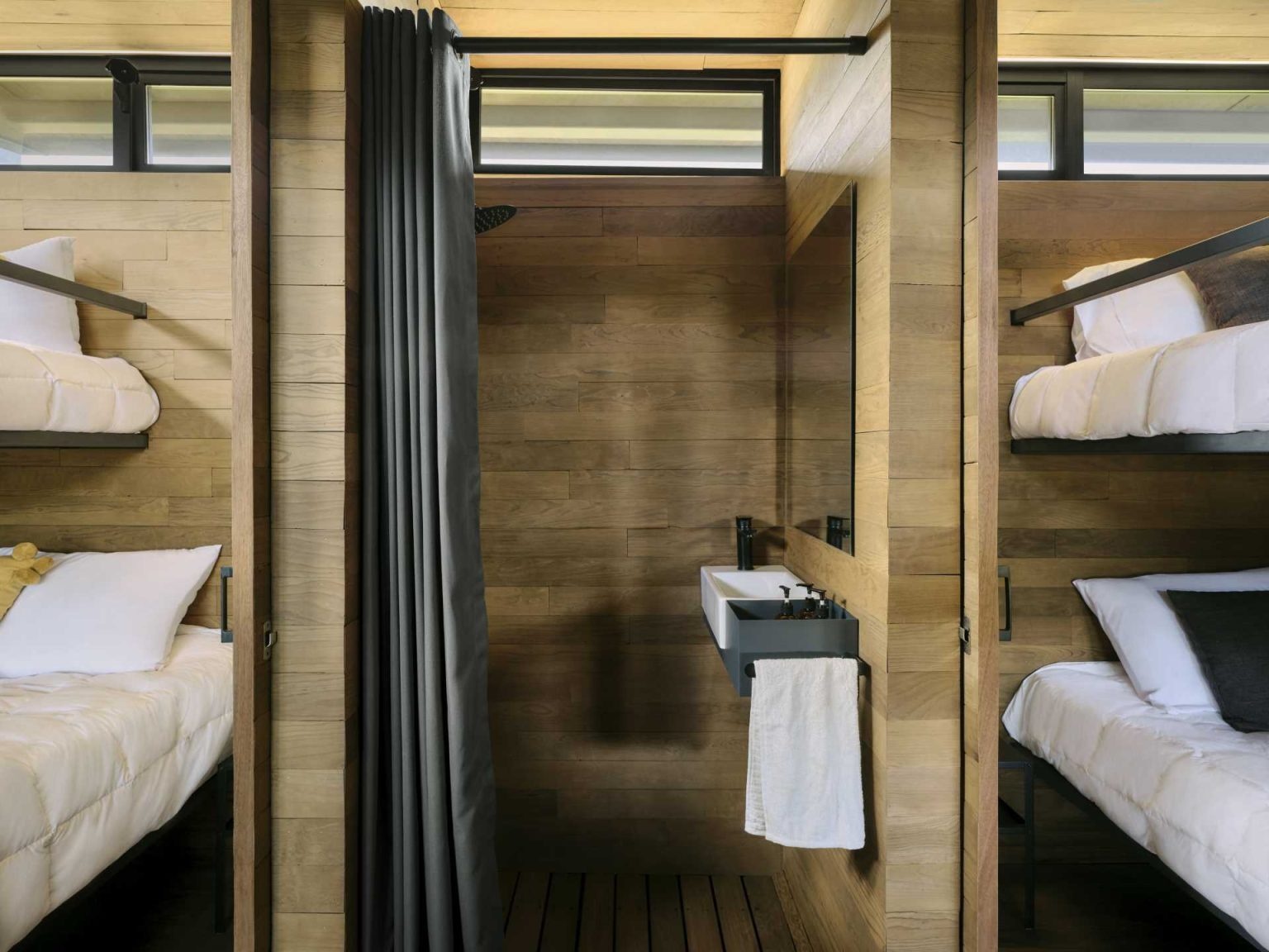 Built-in bunk beds and a centrally placed bathroom show how clever planning makes every centimetre count in this tiny house.