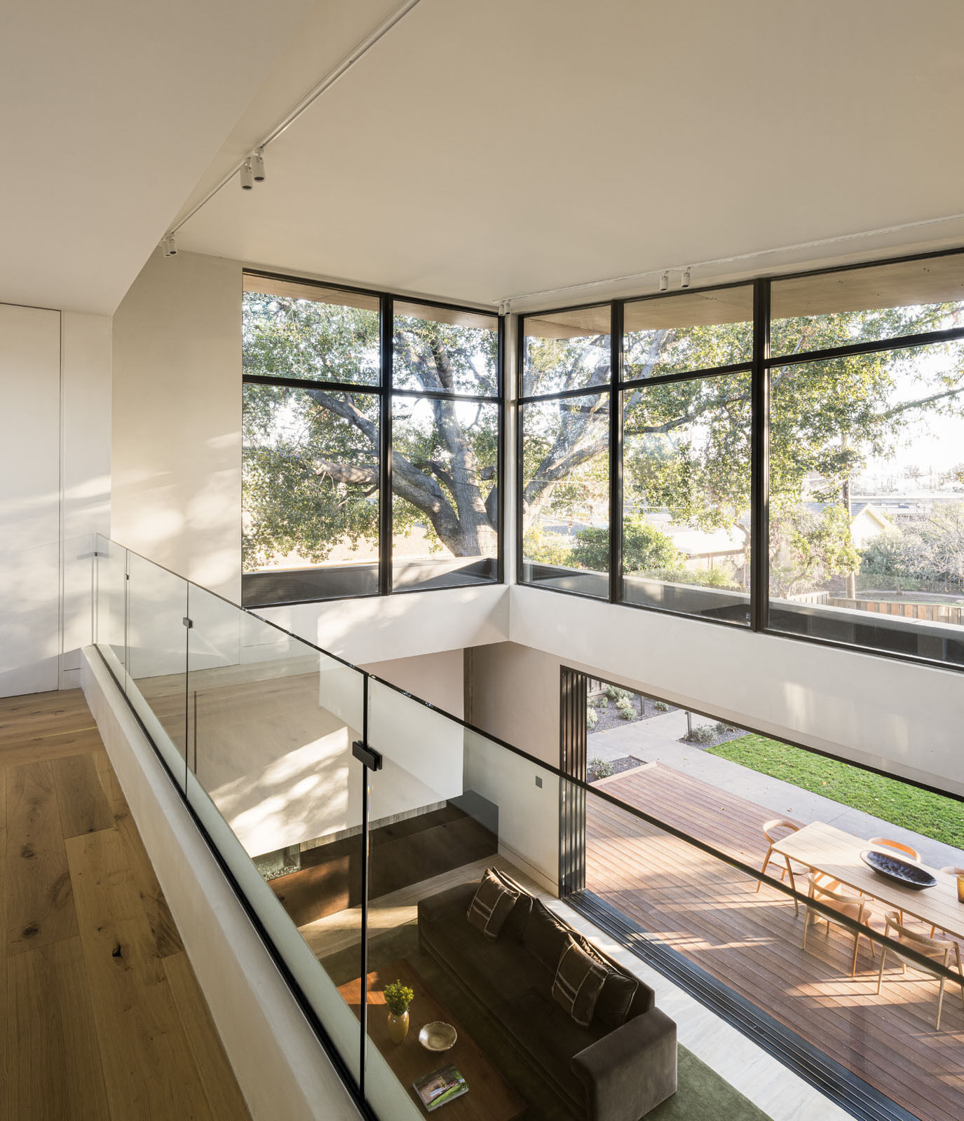 Explore the breezeway and upper-level bridge that connect family spaces while overlooking the bright living room below.