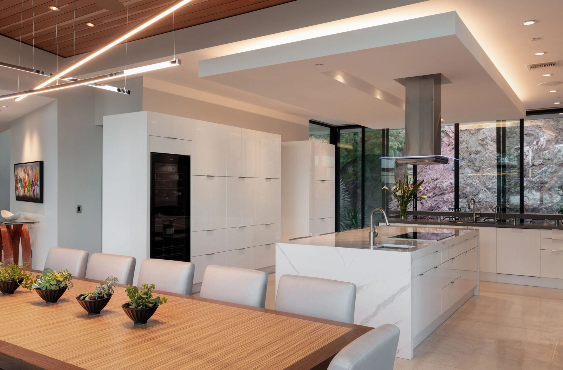 A crisp white kitchen with a large island and panoramic views makes this space one of the home's standout features.