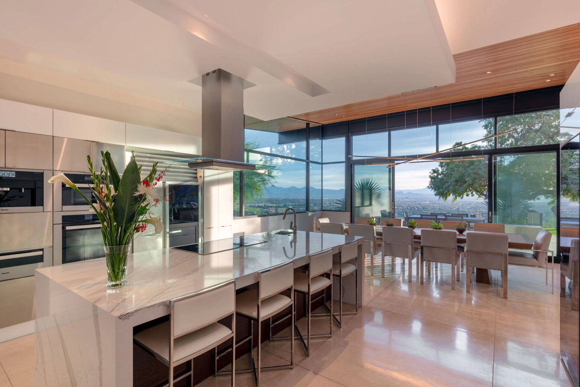 A crisp white kitchen with a large island and panoramic views makes this space one of the home's standout features.