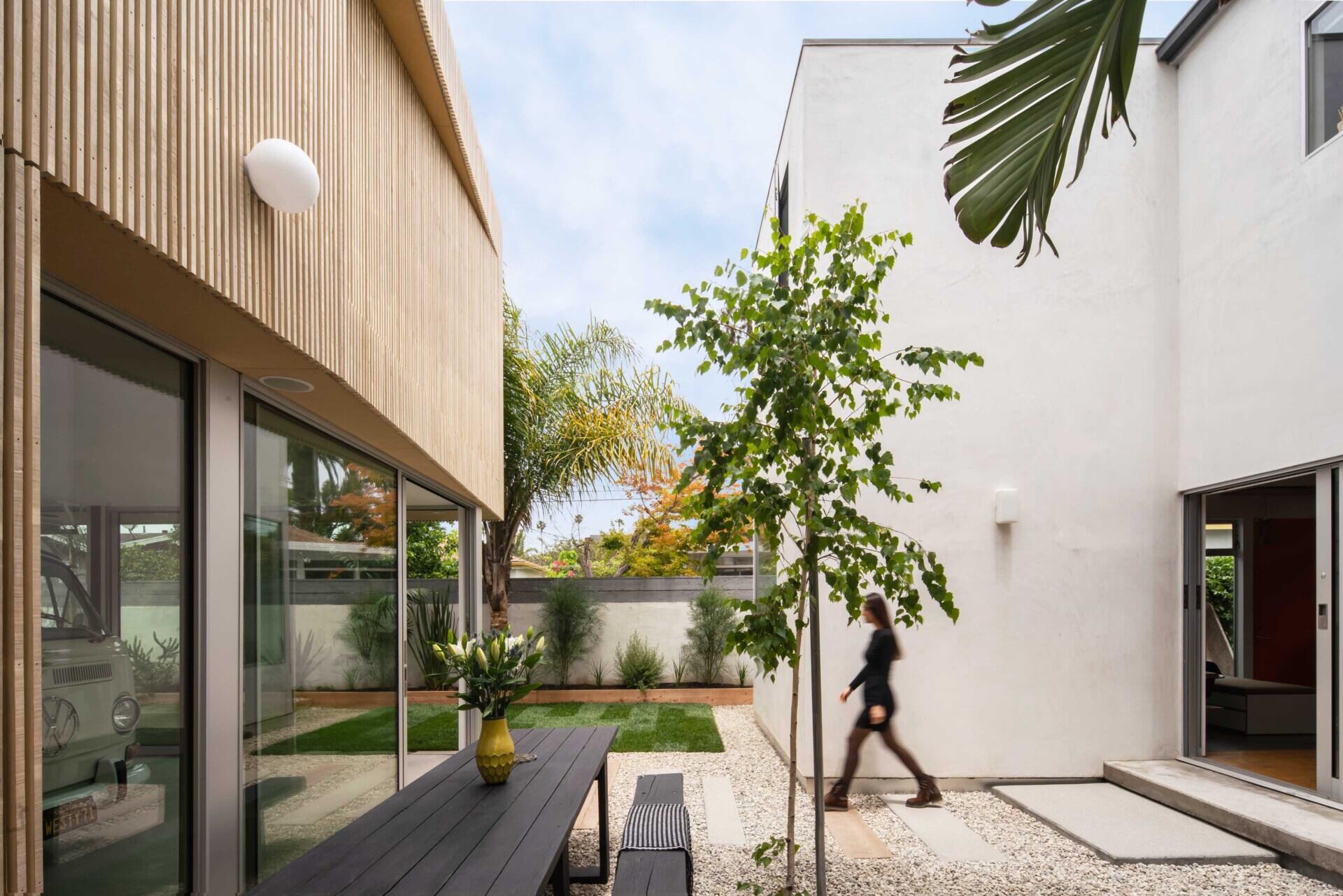 See how a rebuilt garage helped create a beautiful courtyard, more garden space, and a modern backyard layout for this California family home.