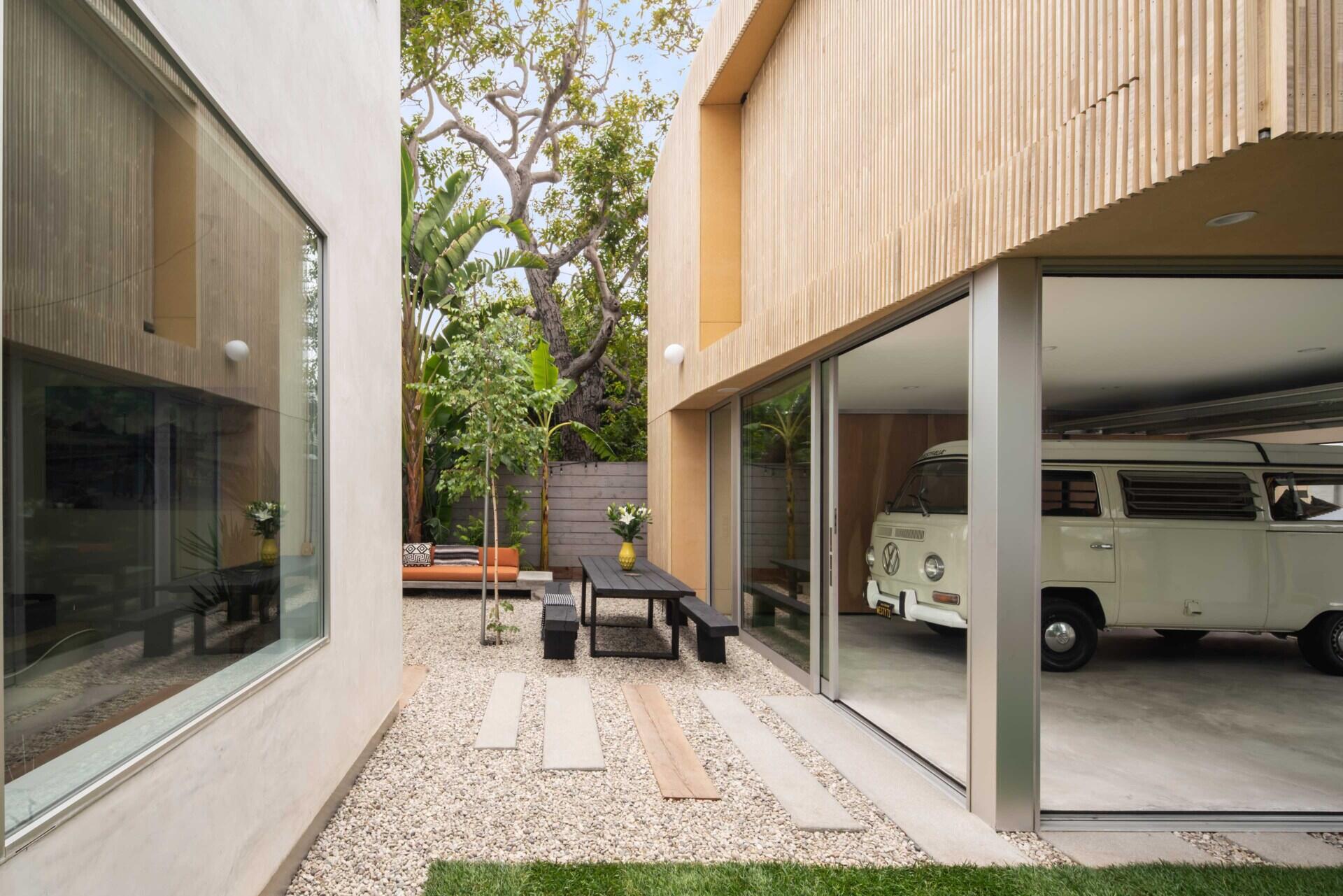 This modern garage proves parking spaces can be beautiful too, with sliding glass walls and a striking timber façade.