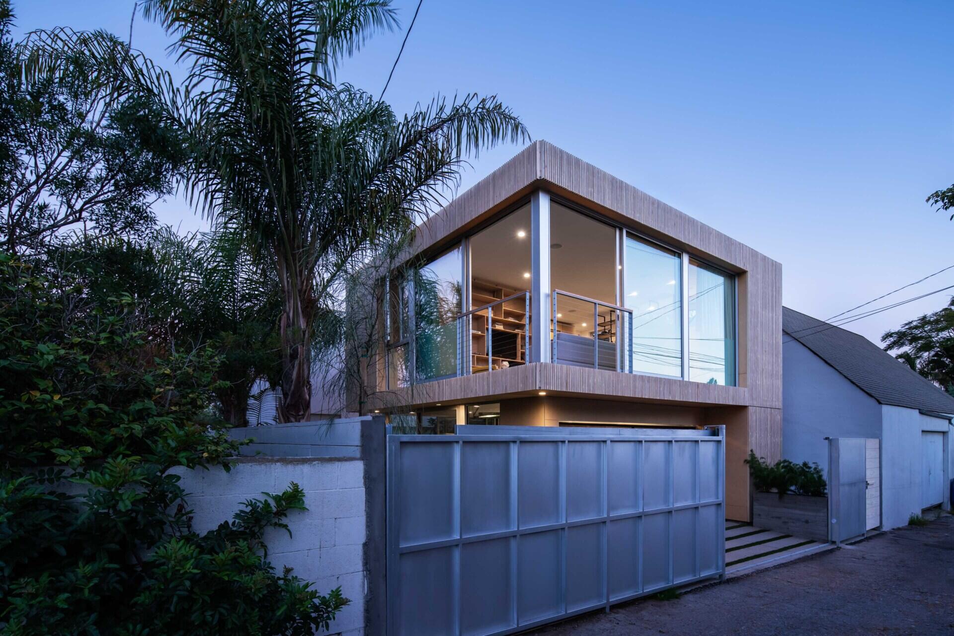 See how lighting and disappearing corner doors completely transform this modern California garage after dark.