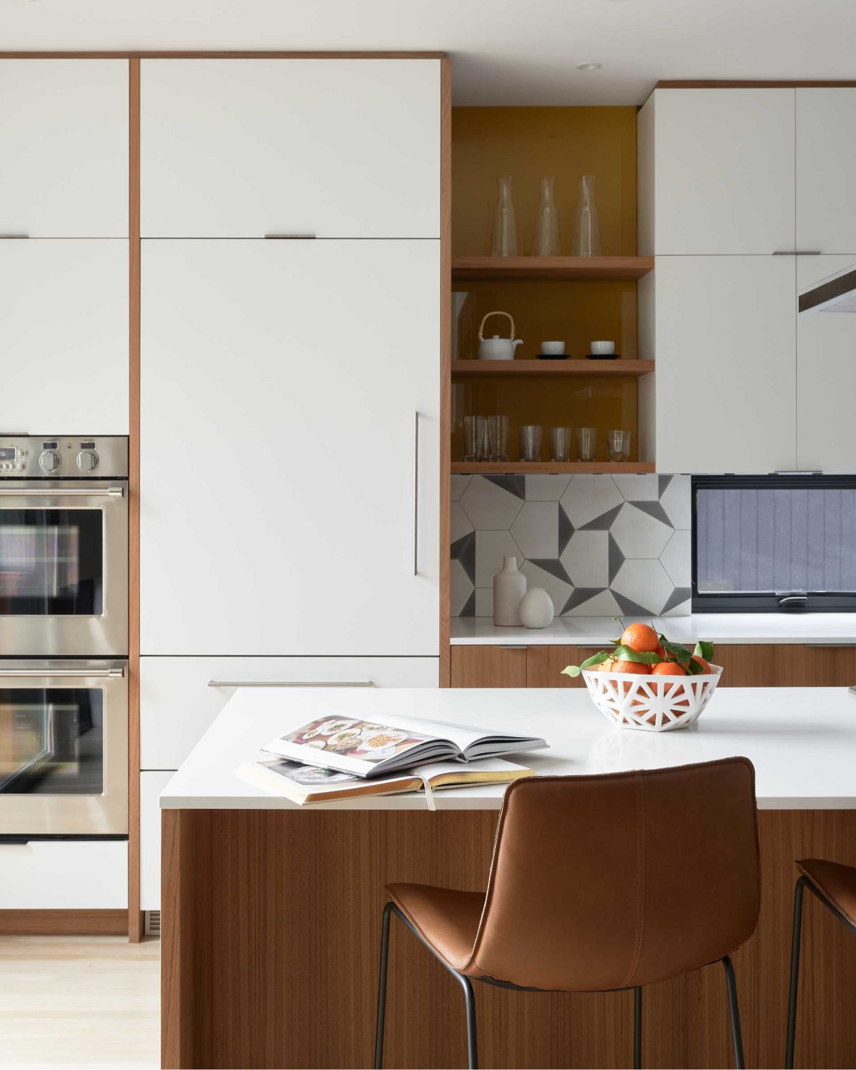 From a dark enclosed kitchen to a bright modern space with ceiling-height cabinetry, wood finishes, and floor-to-ceiling glazing, this renovation is full of inspiration.