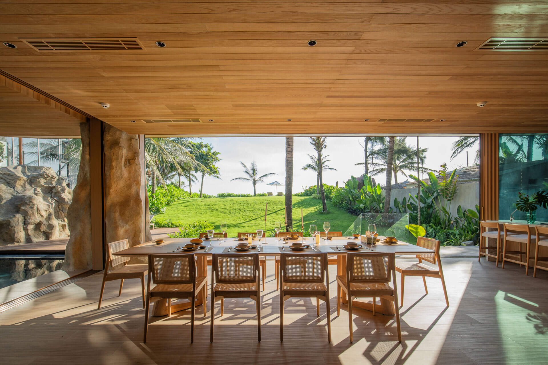 A light-filled dining area sits within the villa's open-plan layout, creating an inviting place for family meals and entertaining.