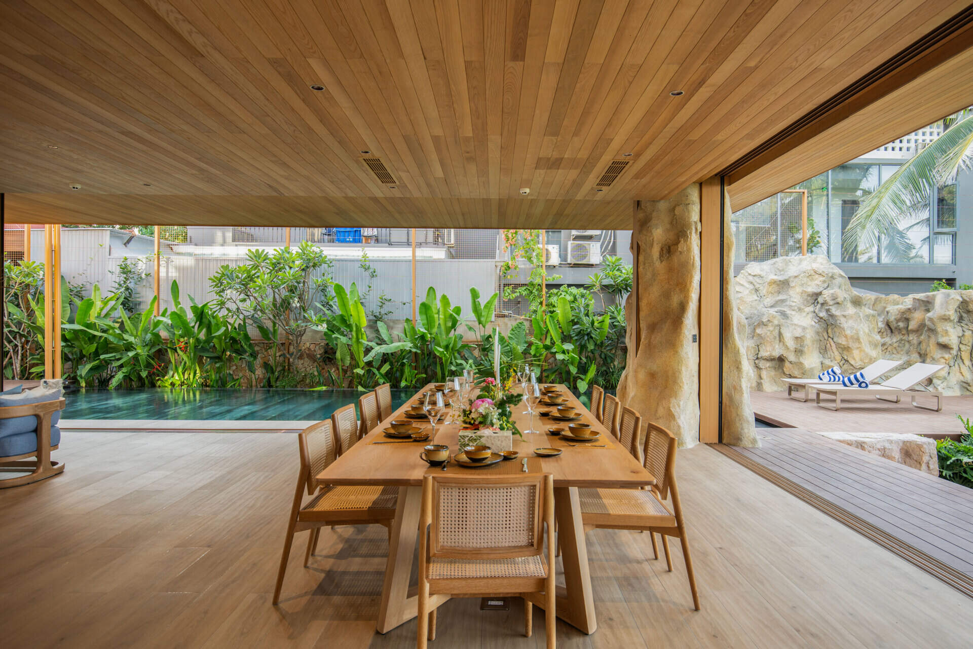 A light-filled dining area sits within the villa's open-plan layout, creating an inviting place for family meals and entertaining.