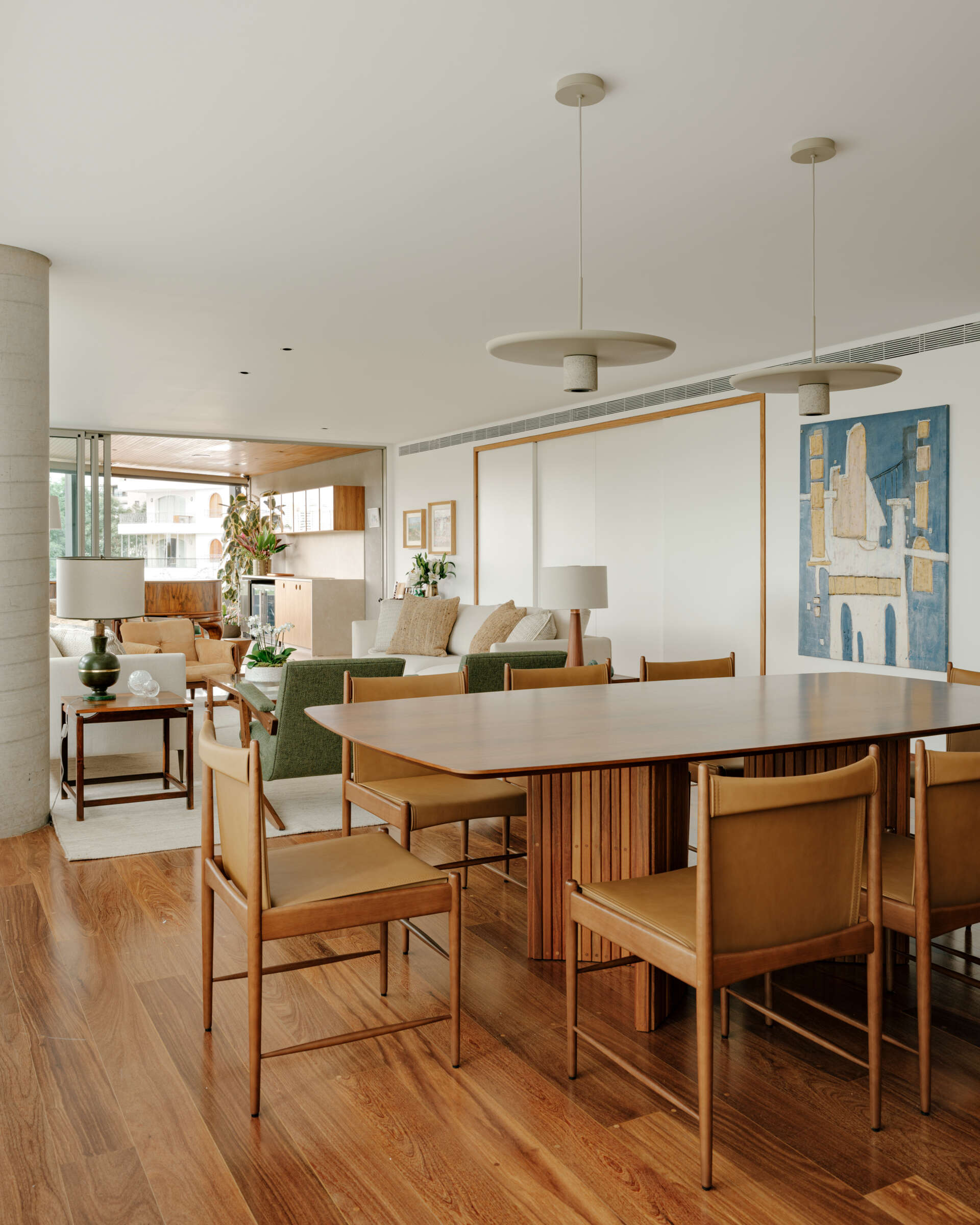 Warm timber, caramel leather and elegant lighting create a dining room that's both refined and inviting.