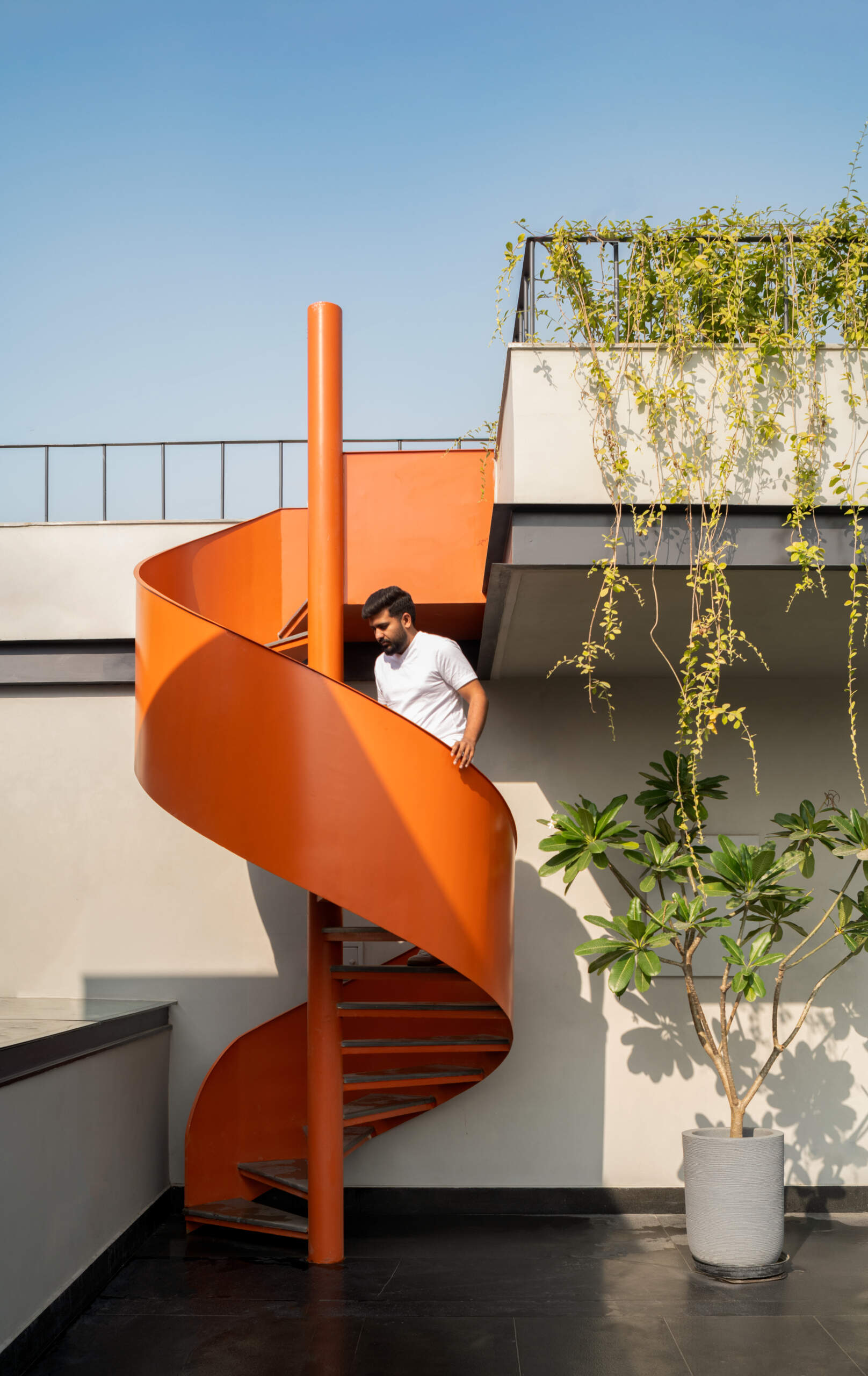 Landscaped rooftop terraces and a vibrant orange spiral staircase add another memorable layer to The Arthouse.