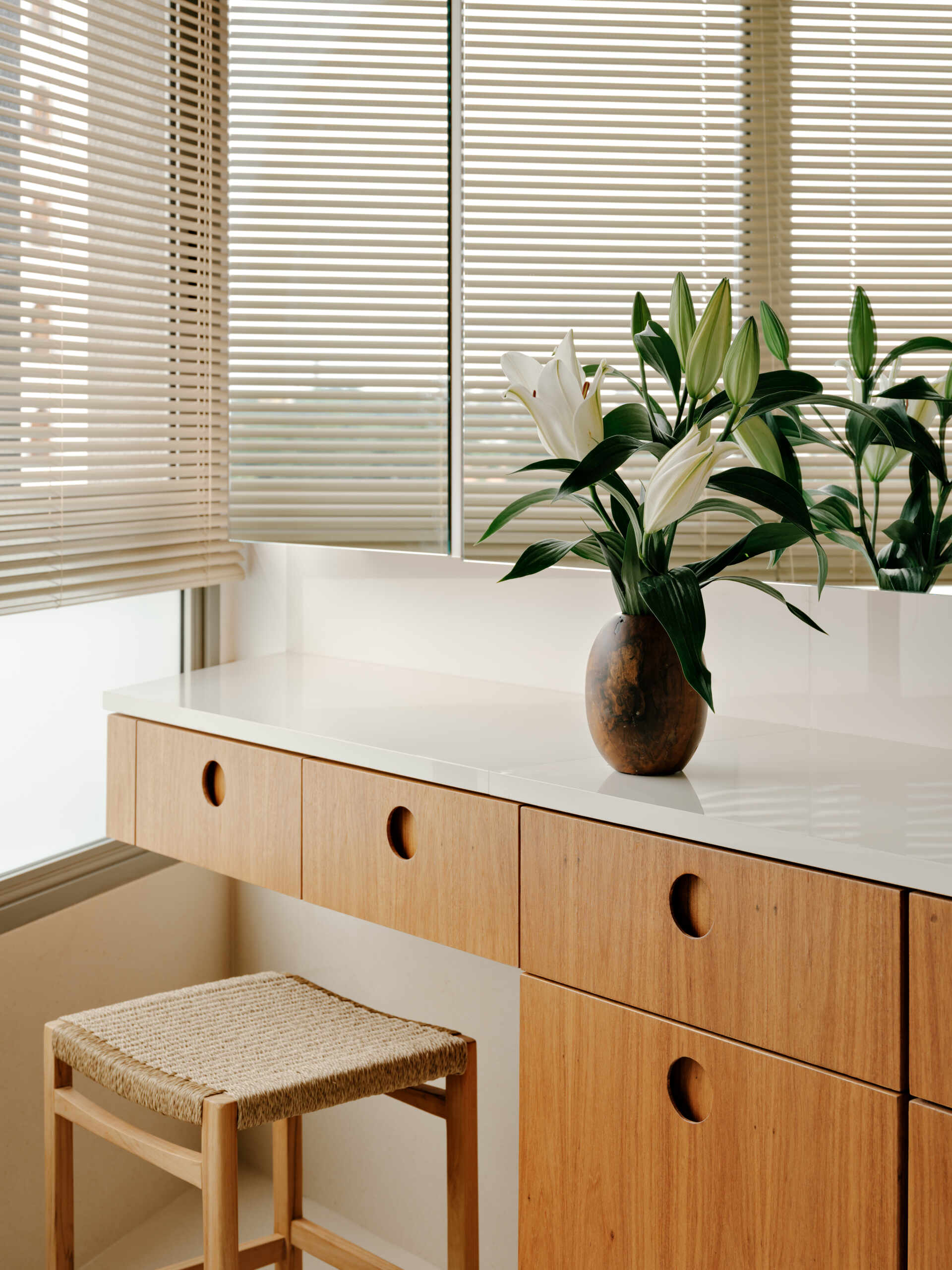Circular joinery details, warm timber and softly illuminated mirrors create elegant contemporary bathrooms.