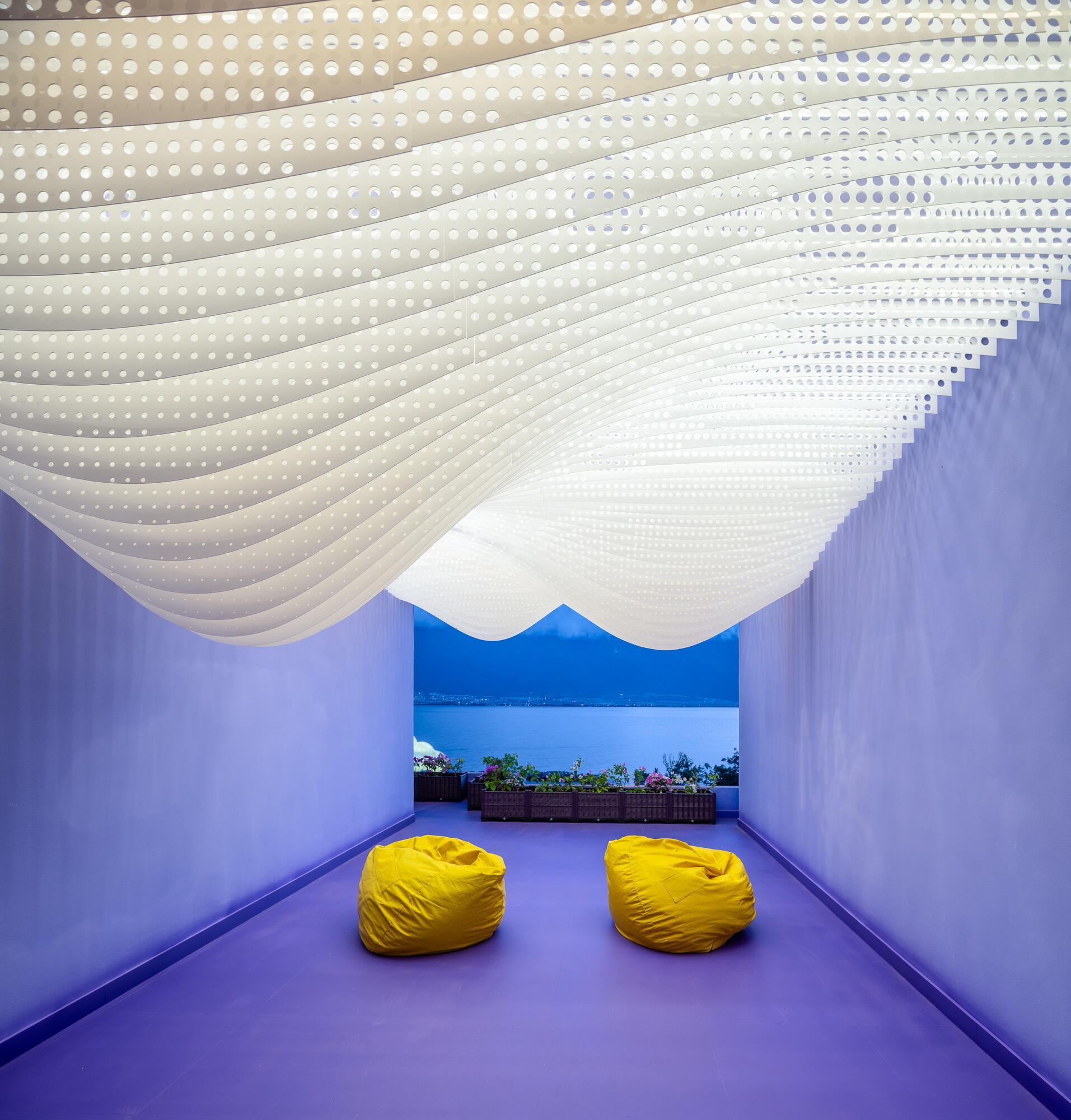 Layered perforated ceiling panels give the Snow Suite the appearance of snow-covered mountain peaks, bringing one of Dali's iconic landscapes indoors.