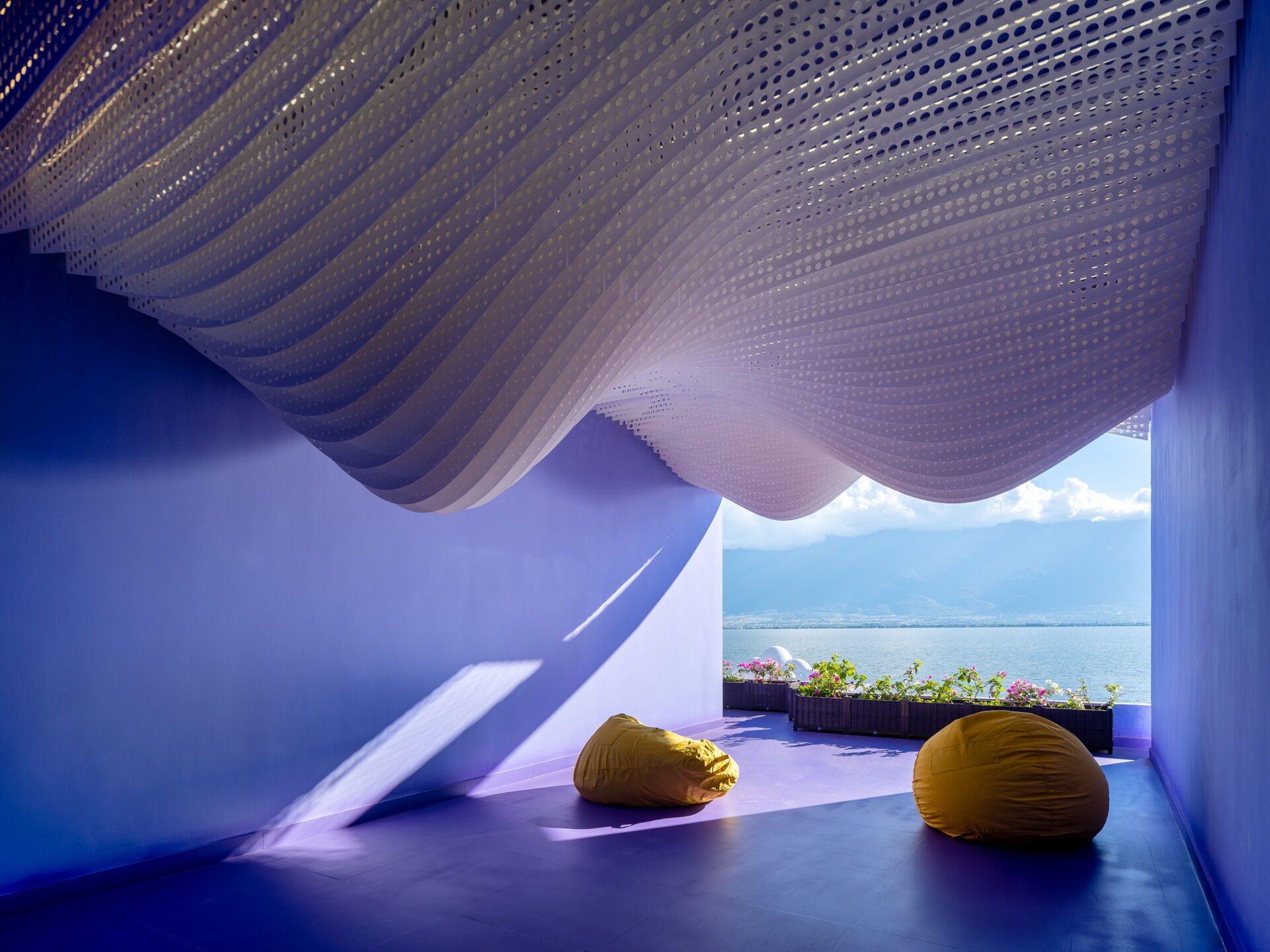Layered perforated ceiling panels give the Snow Suite the appearance of snow-covered mountain peaks, bringing one of Dali's iconic landscapes indoors.
